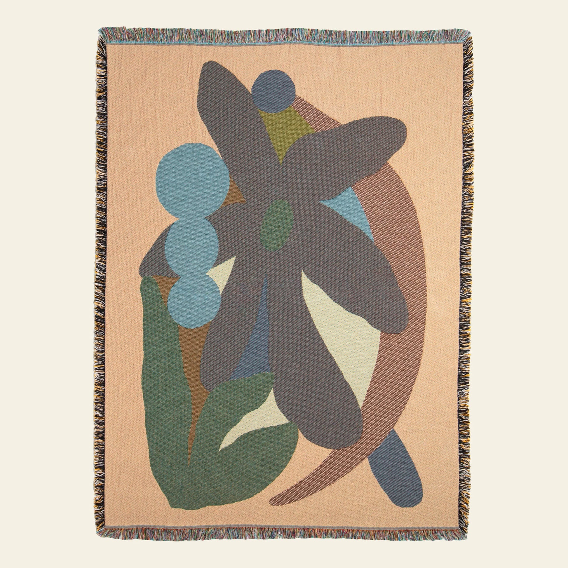 The Slowdown Studio Delaney Throw is a woven recycled cotton blanket by Slowdown Studio, featuring an abstract floral motif in muted green, blue, brown, and beige tones with fringed edges.