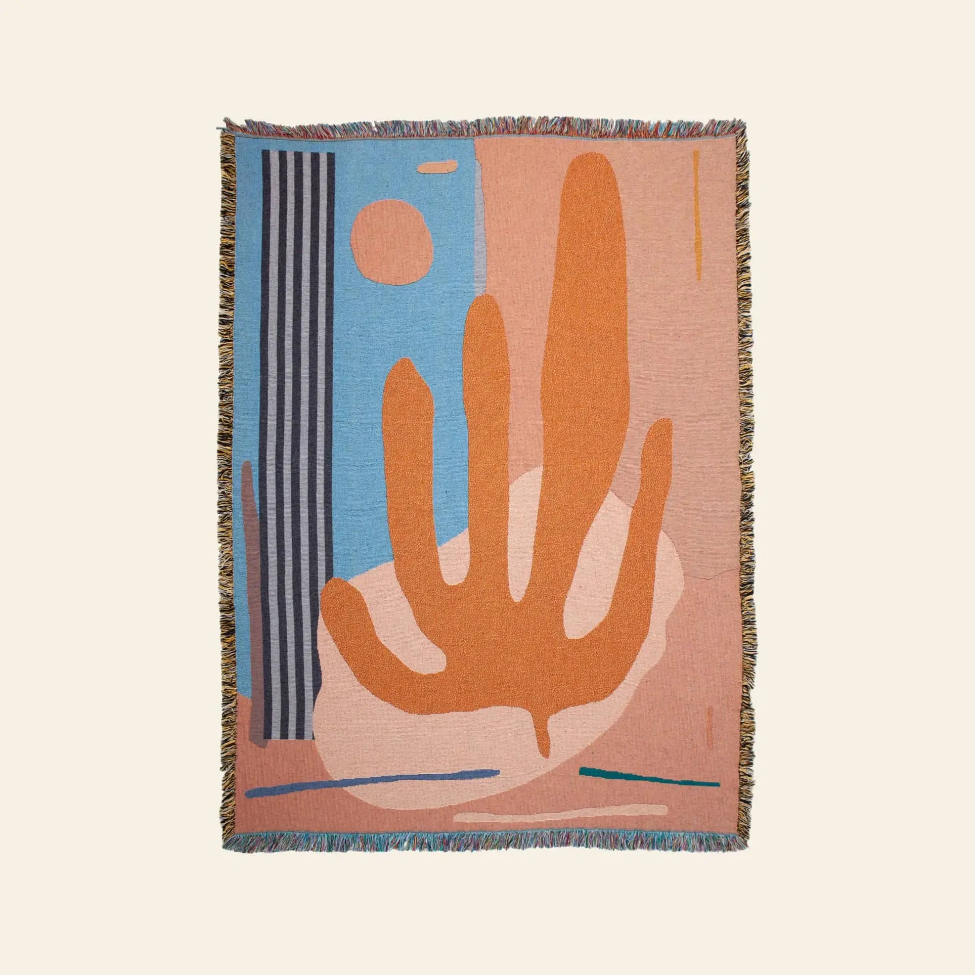 The Slowdown Studio Hazlewood Throw by Slowdown Studio is a sustainable woven blanket with abstract orange, blue, beige, and pink shapes—including a bold orange plant form, vertical blue stripes, a circle, and fringe edges.