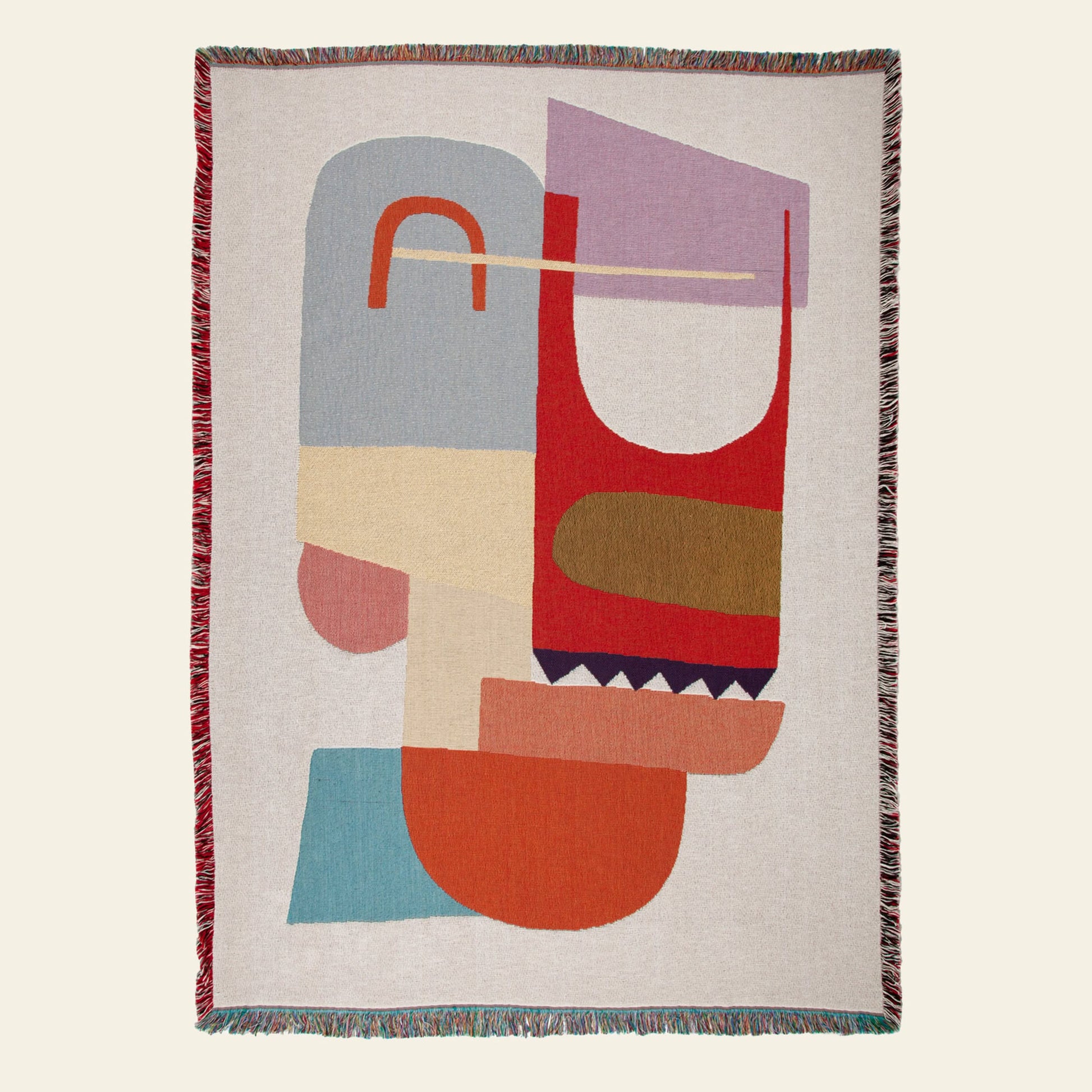 The Slowdown Studio Oroza Throw is a woven blanket with an abstract geometric design and multicolored fringe, made from eco-friendly recycled cotton for a stylish and sustainable touch.