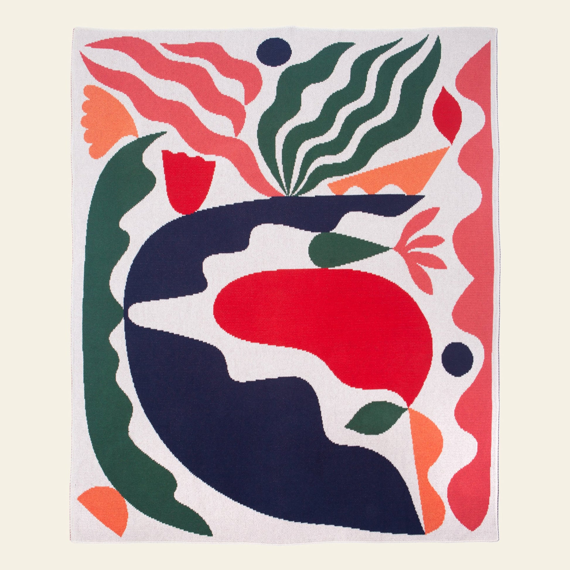 The Slowdown Studio Thurston Knit Blanket by Slowdown Studio is a sustainable, colorful knit made from recycled cotton, featuring abstract wavy shapes in red, green, pink, navy, and orange on a light background.