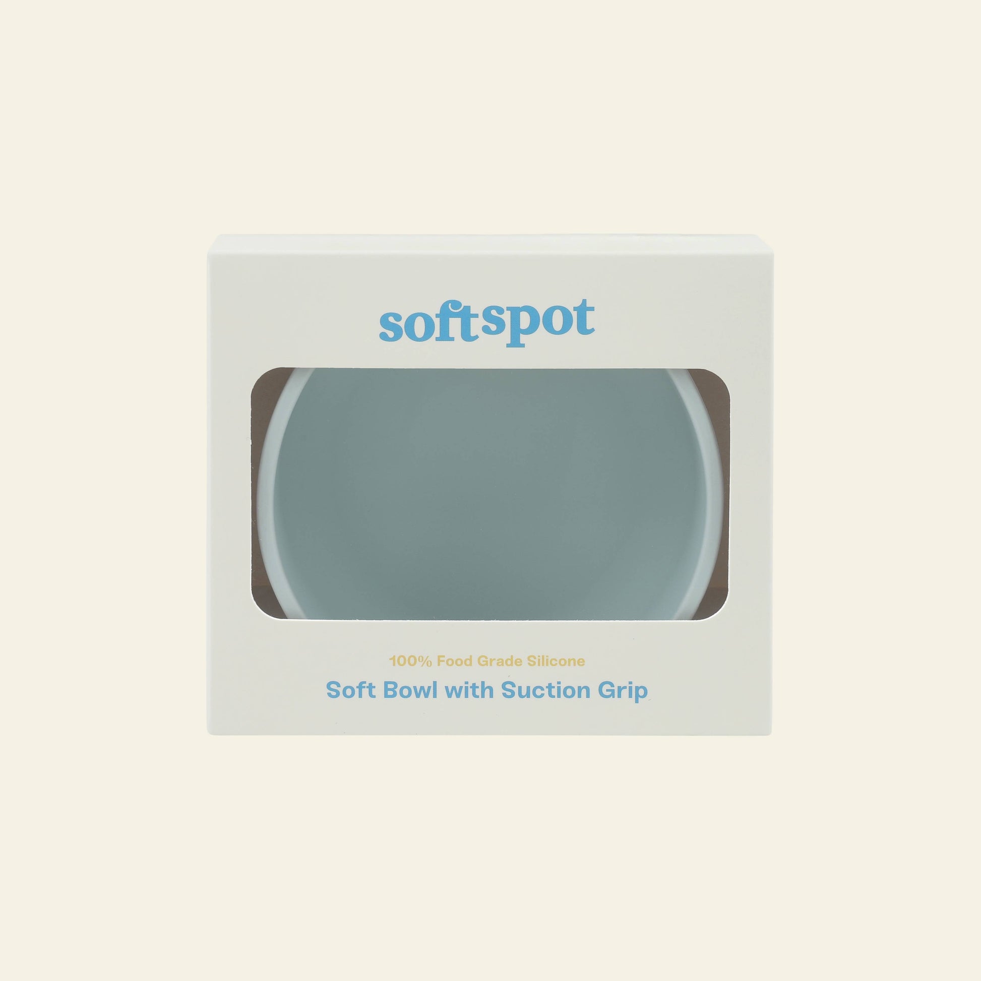 Soft Spot Soft Suction Bowl in light blue comes in white packaging with a clear window. Soft Spot, Soft Suction Bowl, and 100% Food Grade Silicone are printed on the front.