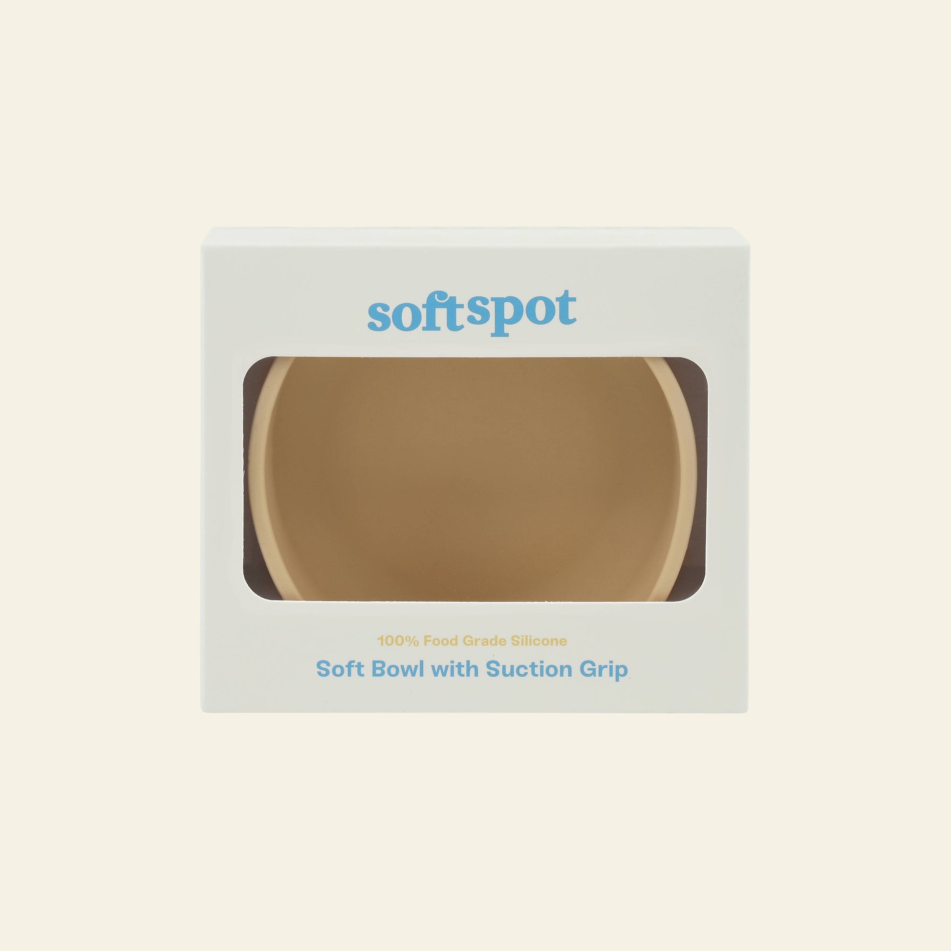 A beige Soft Spot Soft Suction Bowl made from food-grade silicone is packed in a white box with a clear window, featuring “Soft Spot” at the top and “Soft Bowl with Suction Grip” below, emphasizing its secure suction for mess-free meals.