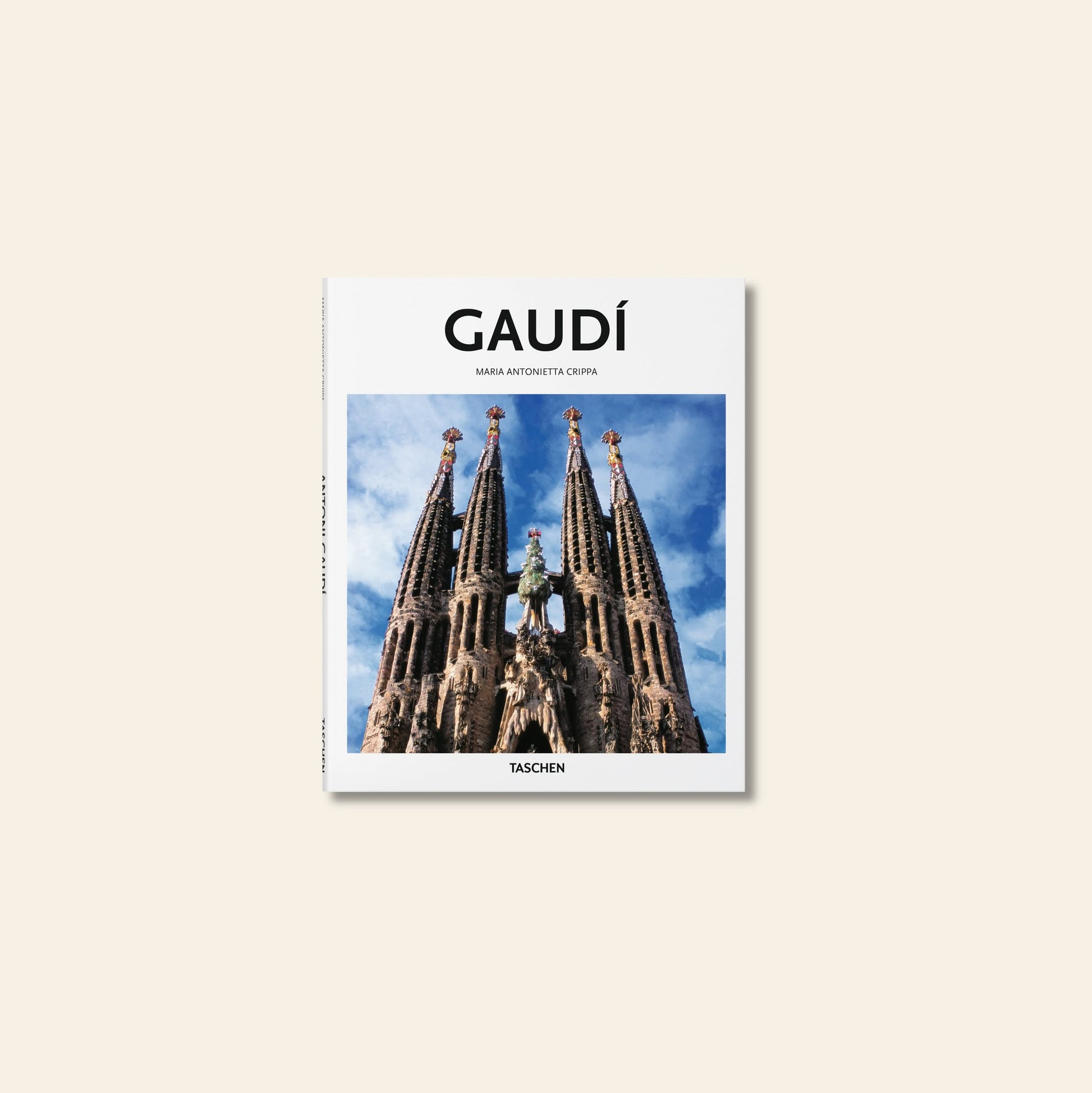 TASCHEN Gaudí by TASCHEN explores Antoni Gaudí’s visionary designs, with the Sagrada Família’s spires set against a blue sky and a plain beige background.