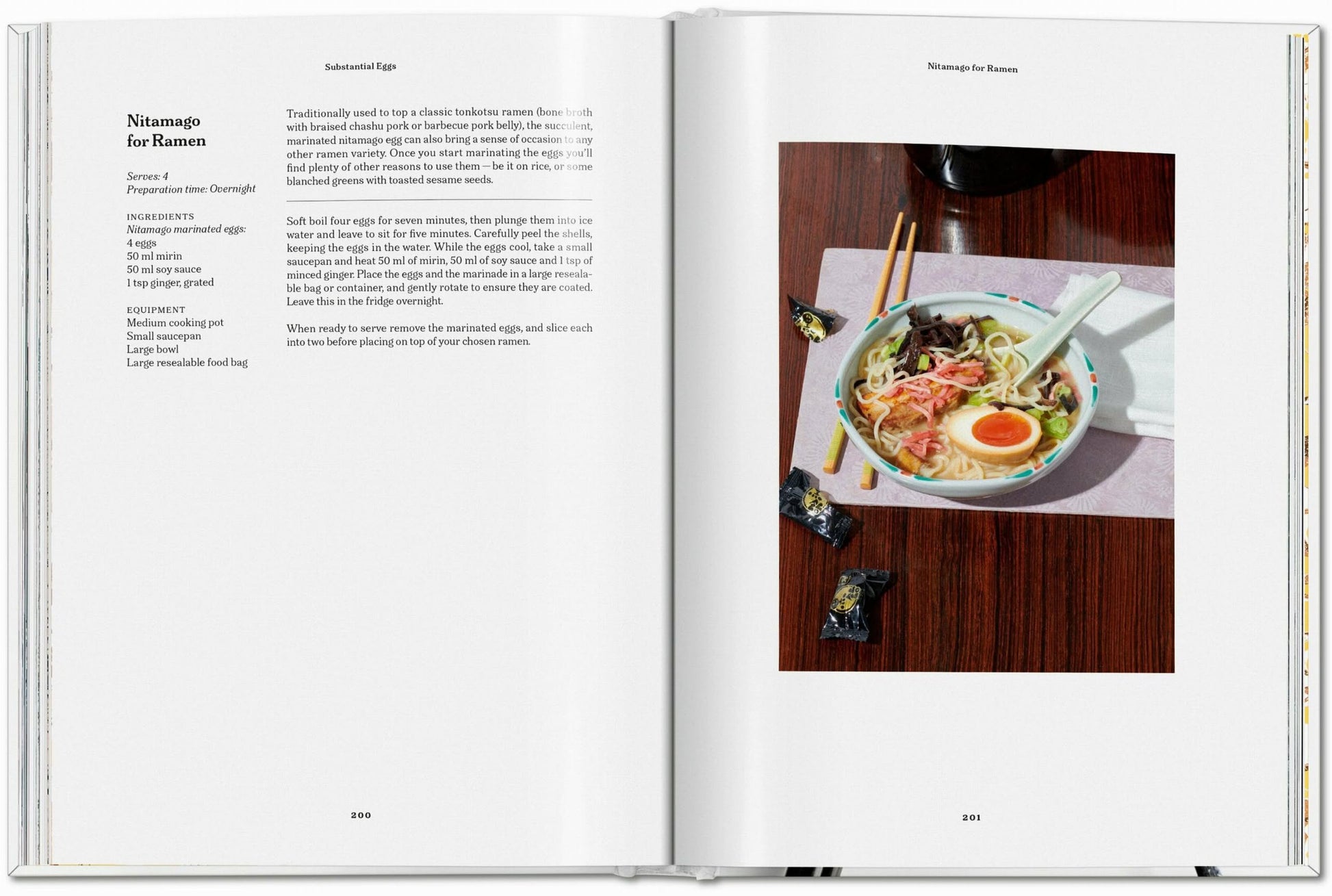 The TASCHEN The Gourmand’s Egg cookbook lies open, with an original Nitamago for Ramen recipe on the left and a photo of ramen with egg, noodles, corn, seaweed, and chopsticks artfully displayed on the right.