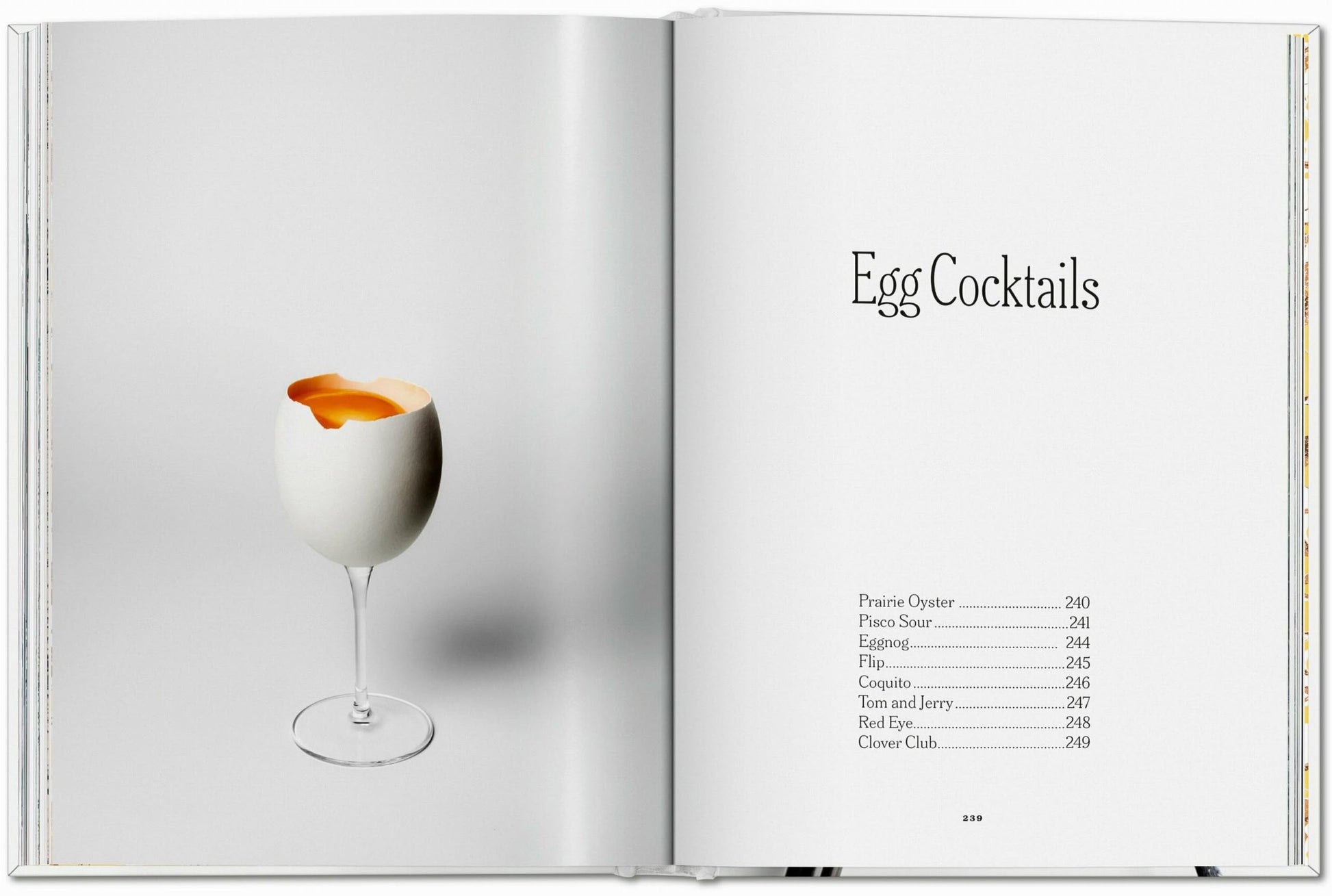 An open book, TASCHEN The Gourmands Egg: A Collection of Stories and Recipes, shows an egg in a wine glass on one page and the title Egg Cocktails with original recipes and page numbers on the other, blending food and art.