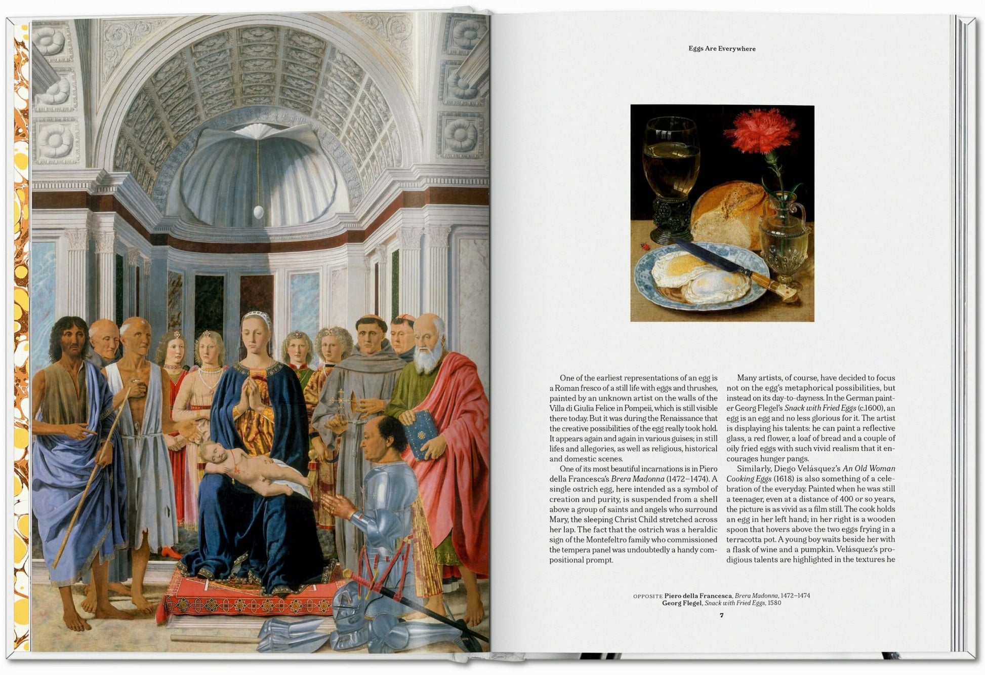 An open TASCHEN The Gourmand’s Egg book features a Renaissance religious painting on the left and, on the right, explores food and art with a still life of bread, cheese, a glass, an egg, and a red flower artfully arranged.