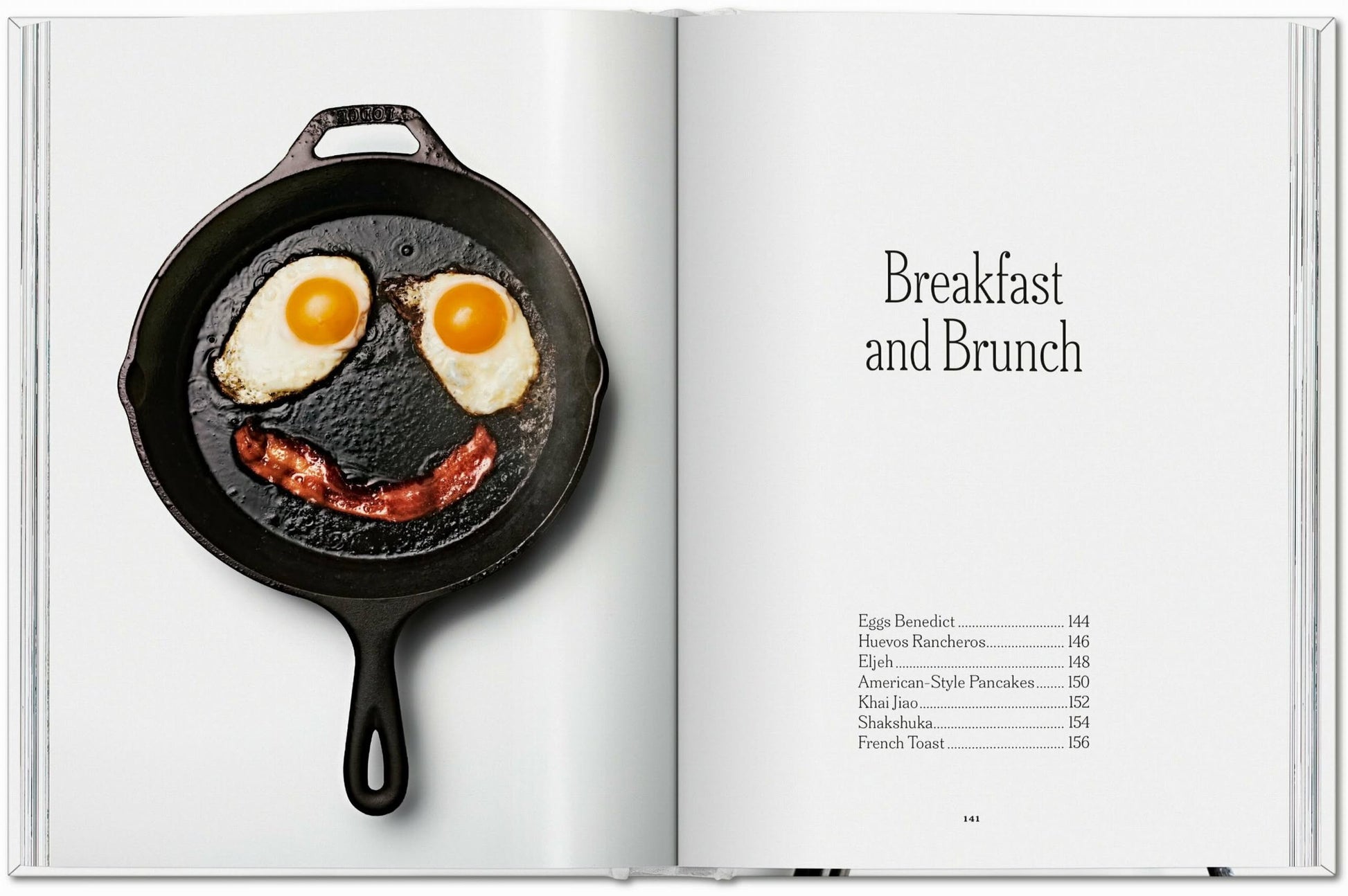 On the left page of TASCHEN The Gourmandʼs Egg: A Collection of Stories and Recipes, a skillet with two eggs and bacon forms a smiling face. The right page lists Breakfast and Brunch recipes with page numbers.