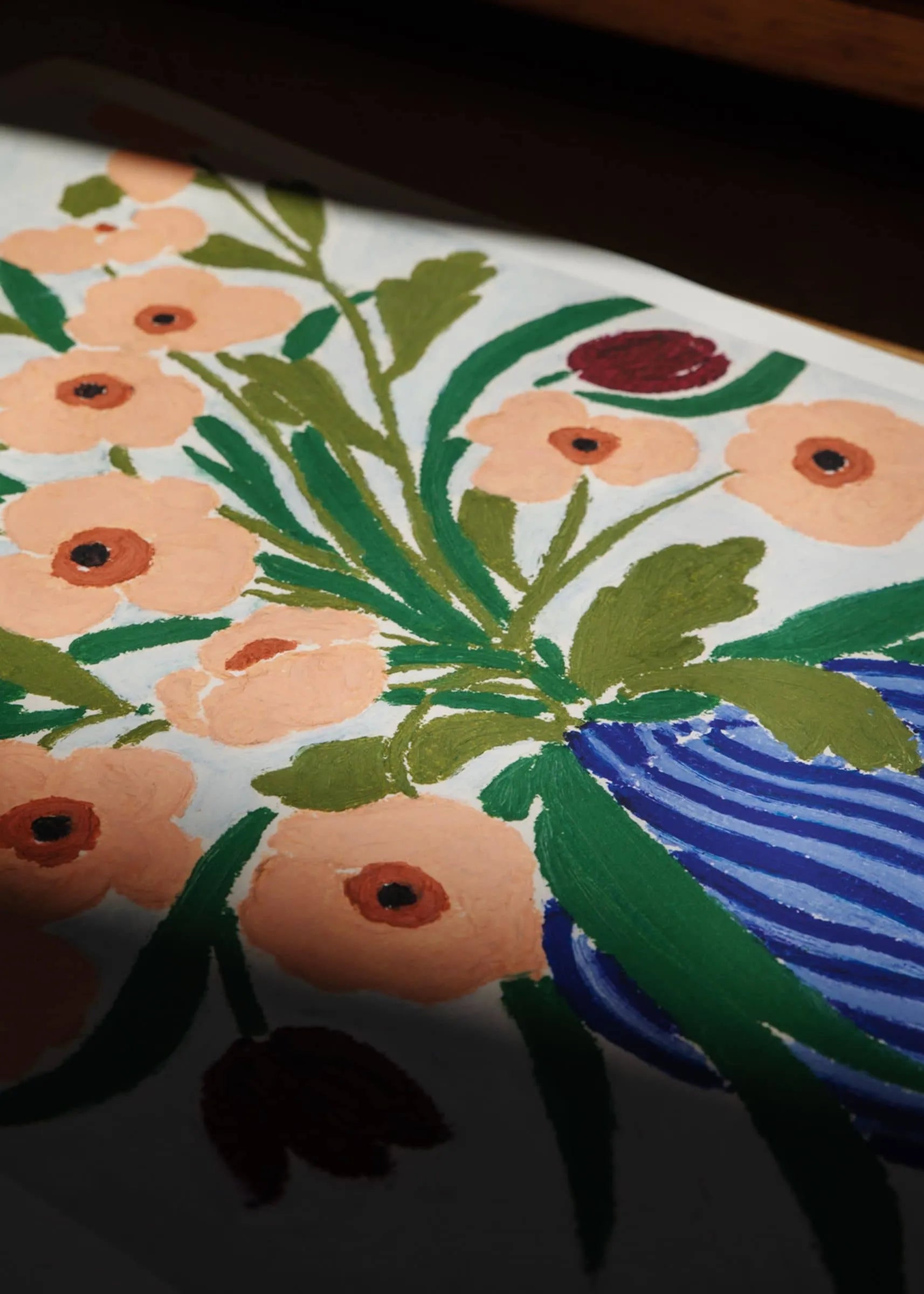Anine Cecilie Iversen - Cerulean Still Life (30x40) by The Poster Club features vibrant orange flowers with green leaves in a blue-striped vase, inspired by Iversen’s Danish style. Available as a fine art giclée print.