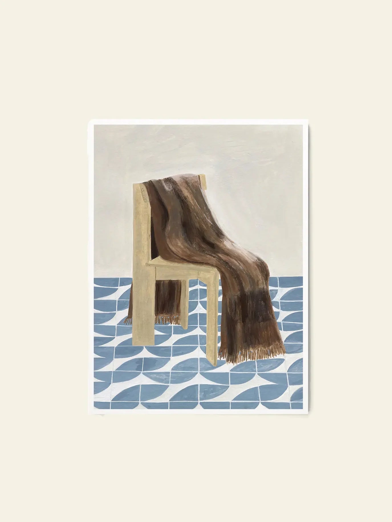 The Poster Club Isabelle Vandeplassche - Chair With Blanket (70x100): An art print featuring a wooden chair with a brown striped blanket, set on a blue geometric floor against a plain light background. Brand: The Poster Club.