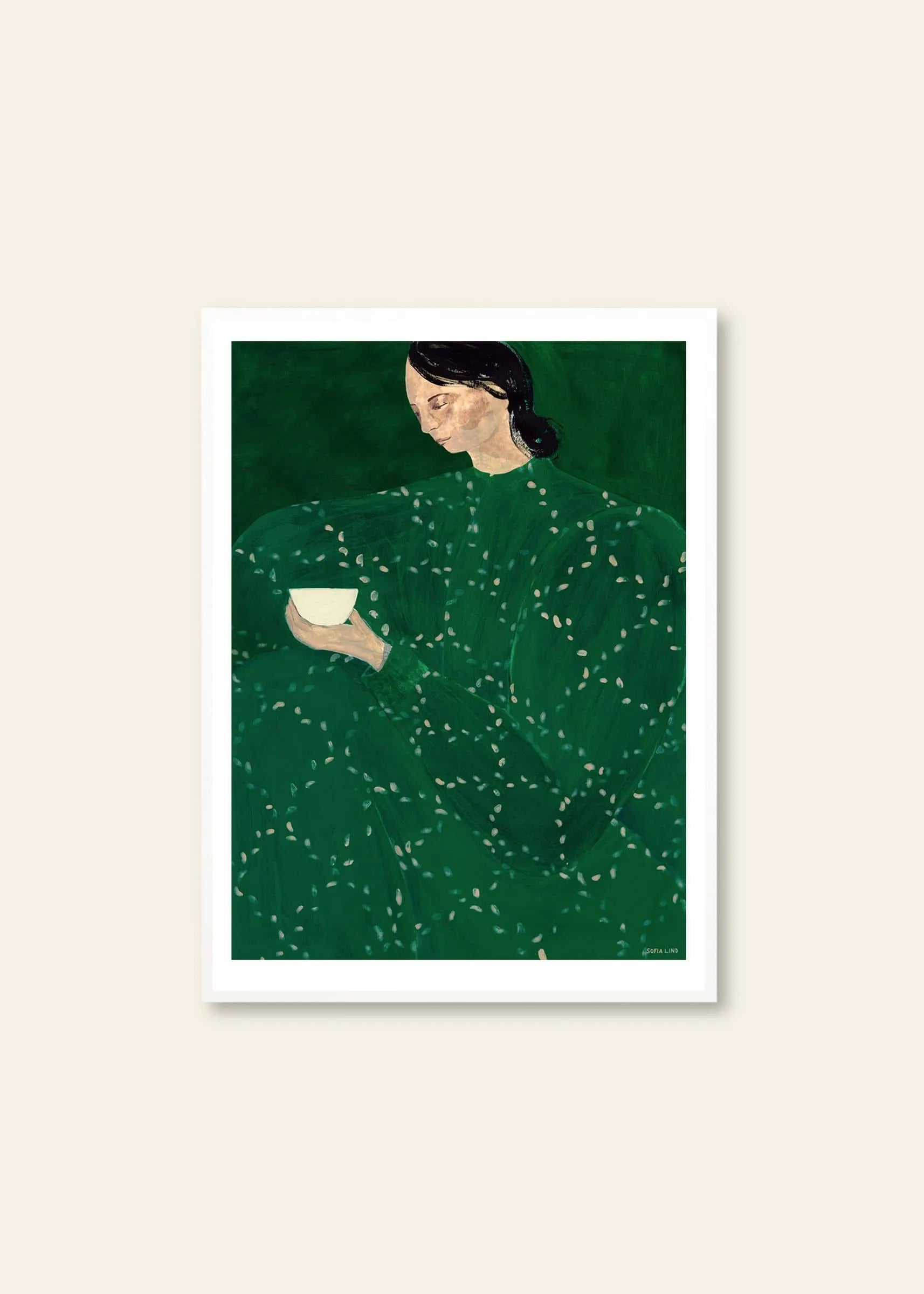 Sofia Lind’s Coffee Alone At Place De Clichy (30x40) by The Poster Club depicts a dark-haired figure in green with a white cup against deep green, presented as a fine art giclée print with white border on a beige wall.