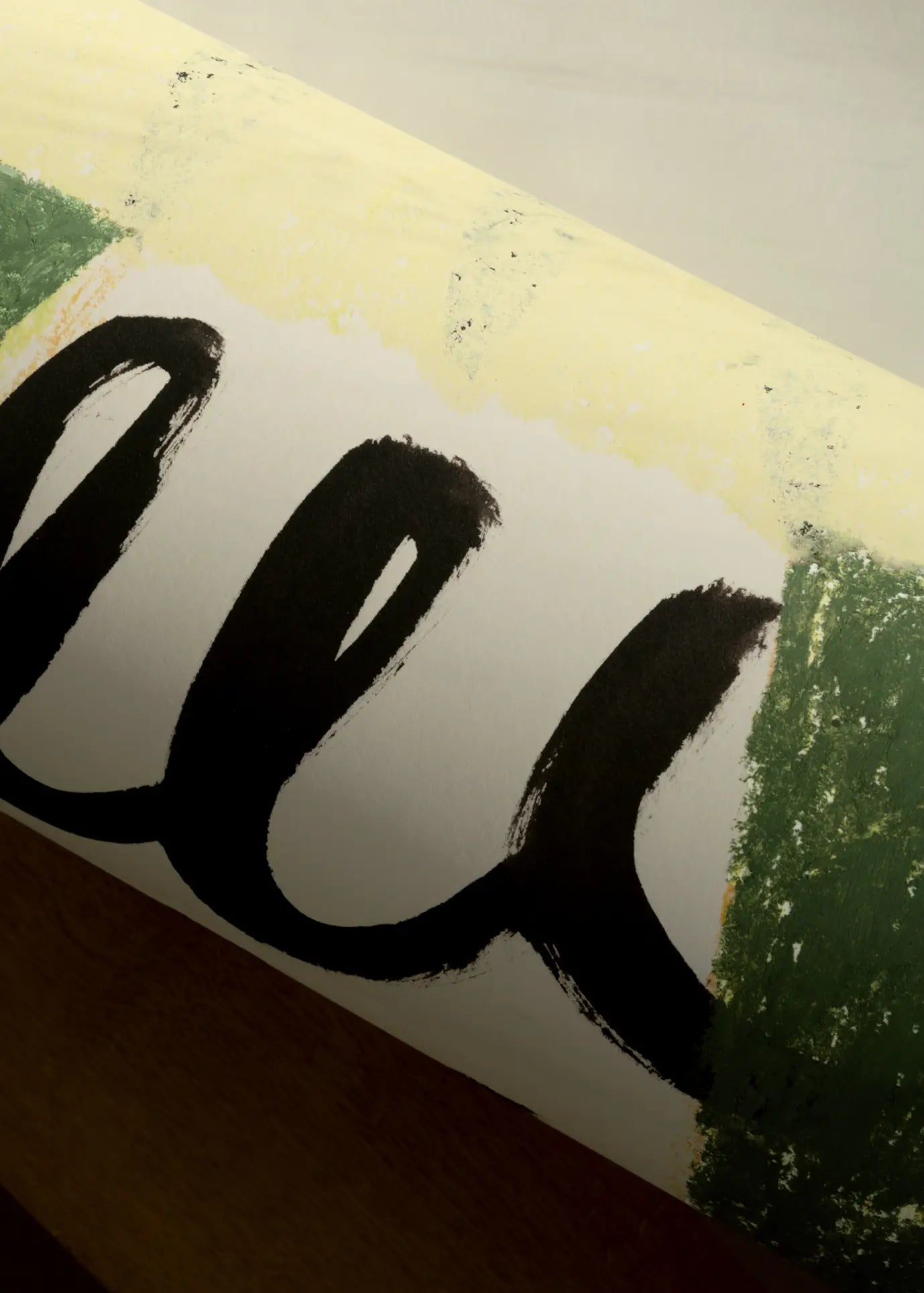 A close-up of The Poster Club Suzanne Lustig - Energize (30x40) art print shows a rolled poster with bold black cursive text on white, bordered by green and yellow paint smudges.