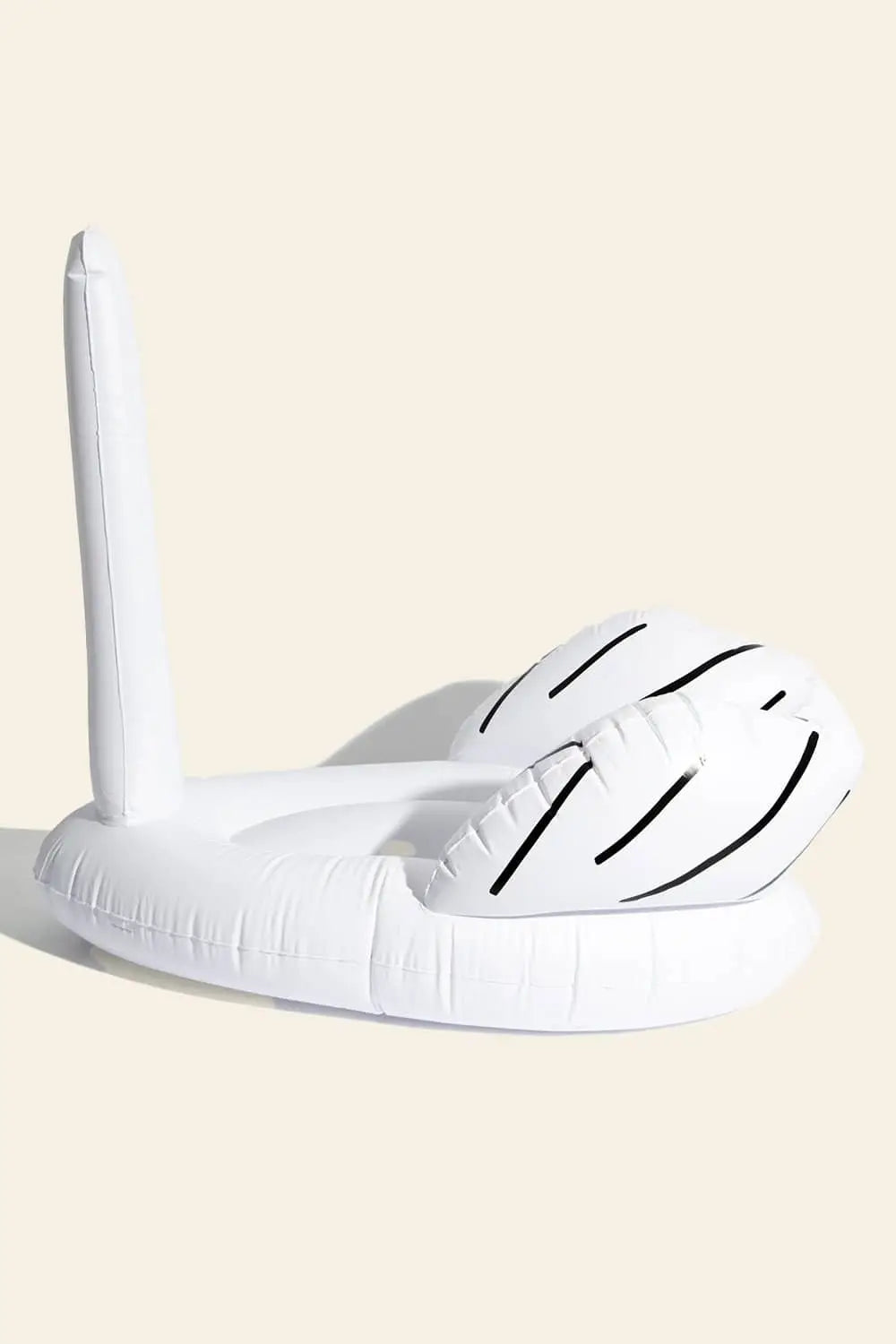 A quirky white inflatable hand pool float with black detailing, inspired by the Ridiculous Inflatable Swan-Thing by David Shrigley for Third Drawer Down, sits against a plain light background.