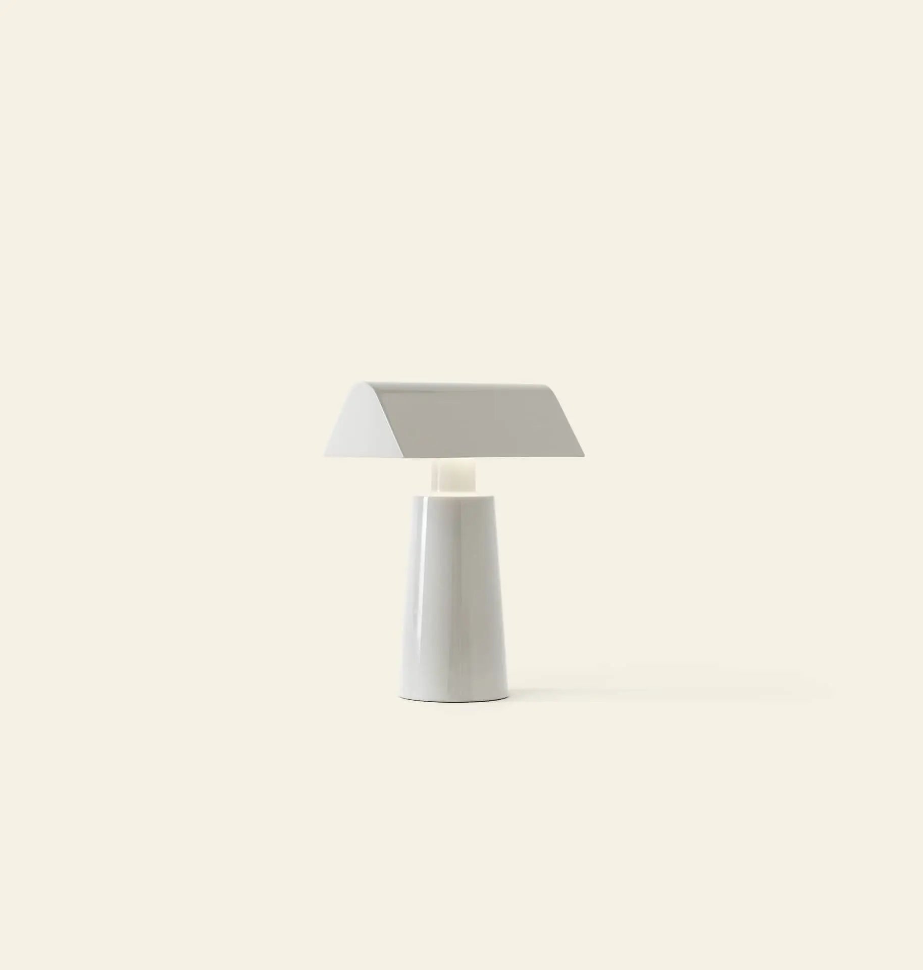 The &Tradition Caret MF1 Portable Table Lamp by &Tradition features a minimalist white design with a flat, wide rectangular shade and tapered cylindrical base, shown against a plain light beige background.