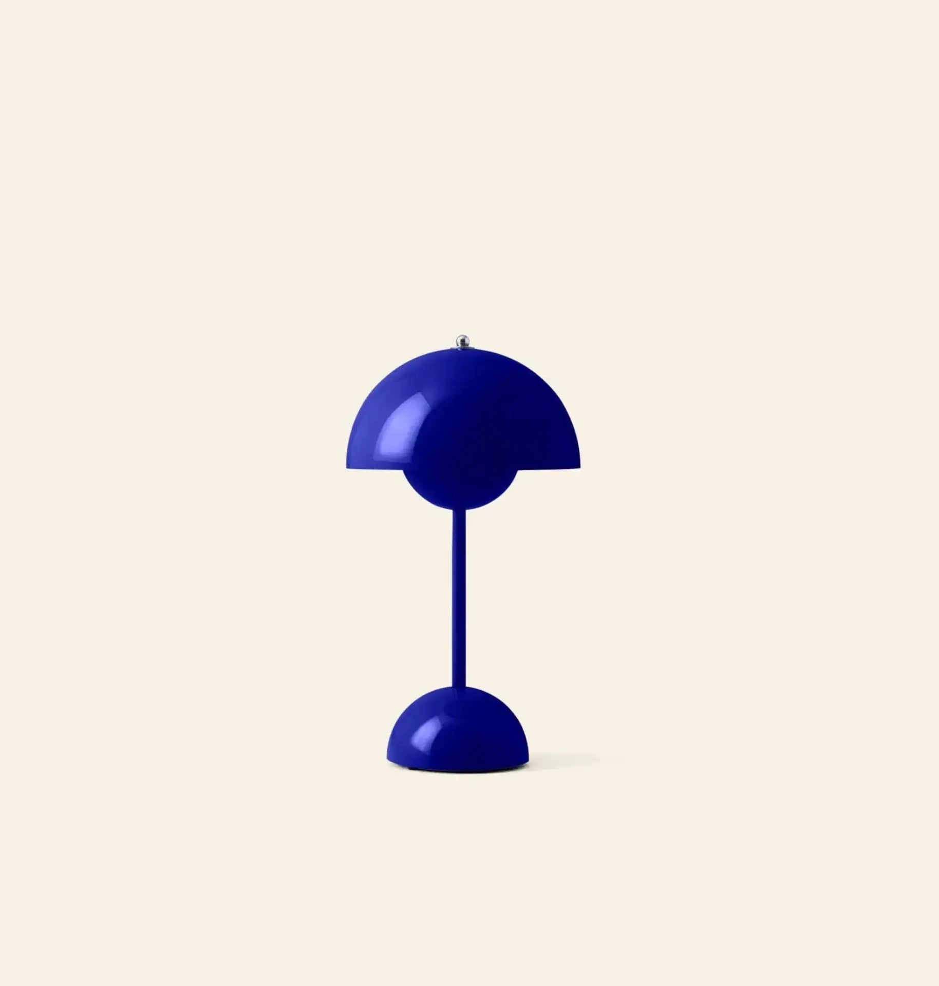 The &Tradition Flowerpot VP9 Portable Table Lamp by &Tradition features a glossy deep blue dome shade and base, set against a plain beige background. Comes with a USB charging cable for convenient use.