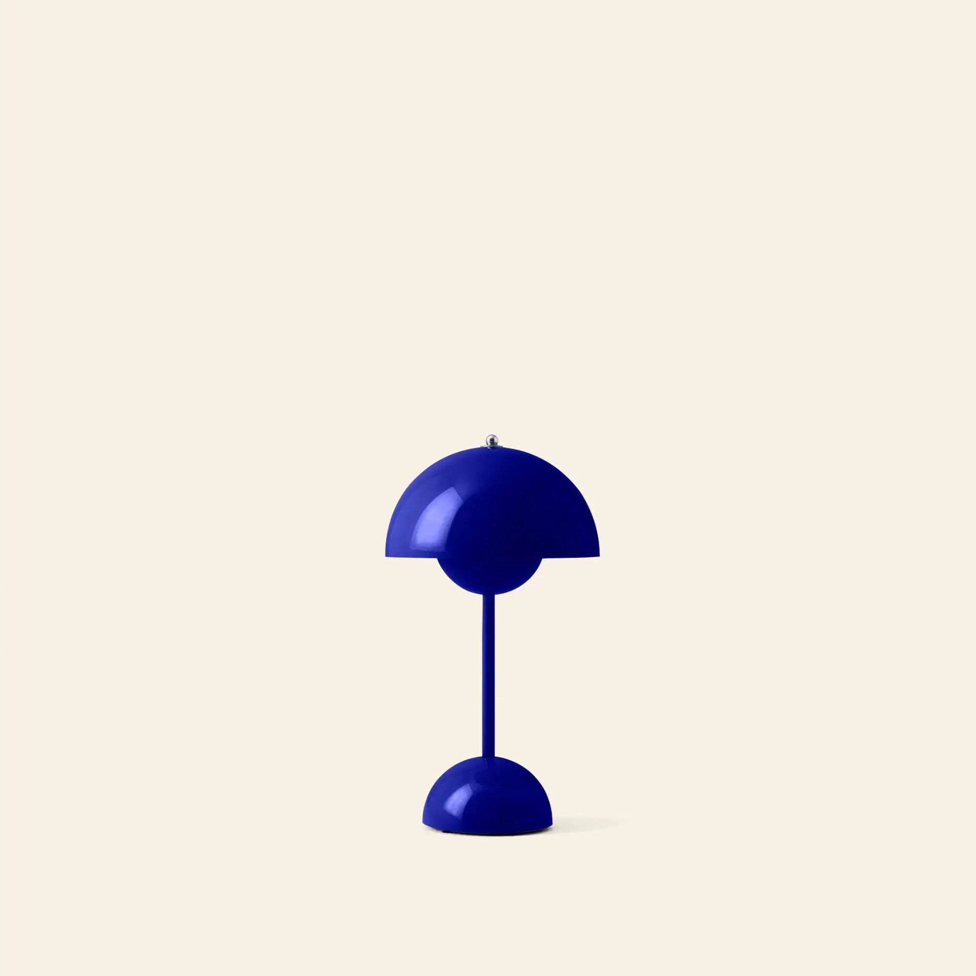 The &Tradition Flowerpot VP9 Portable Table Lamp by &Tradition features a modern blue dome-shaped shade and base, set against a plain beige background. Its minimalist design emphasizes portable VP9 function and USB charging compatibility.