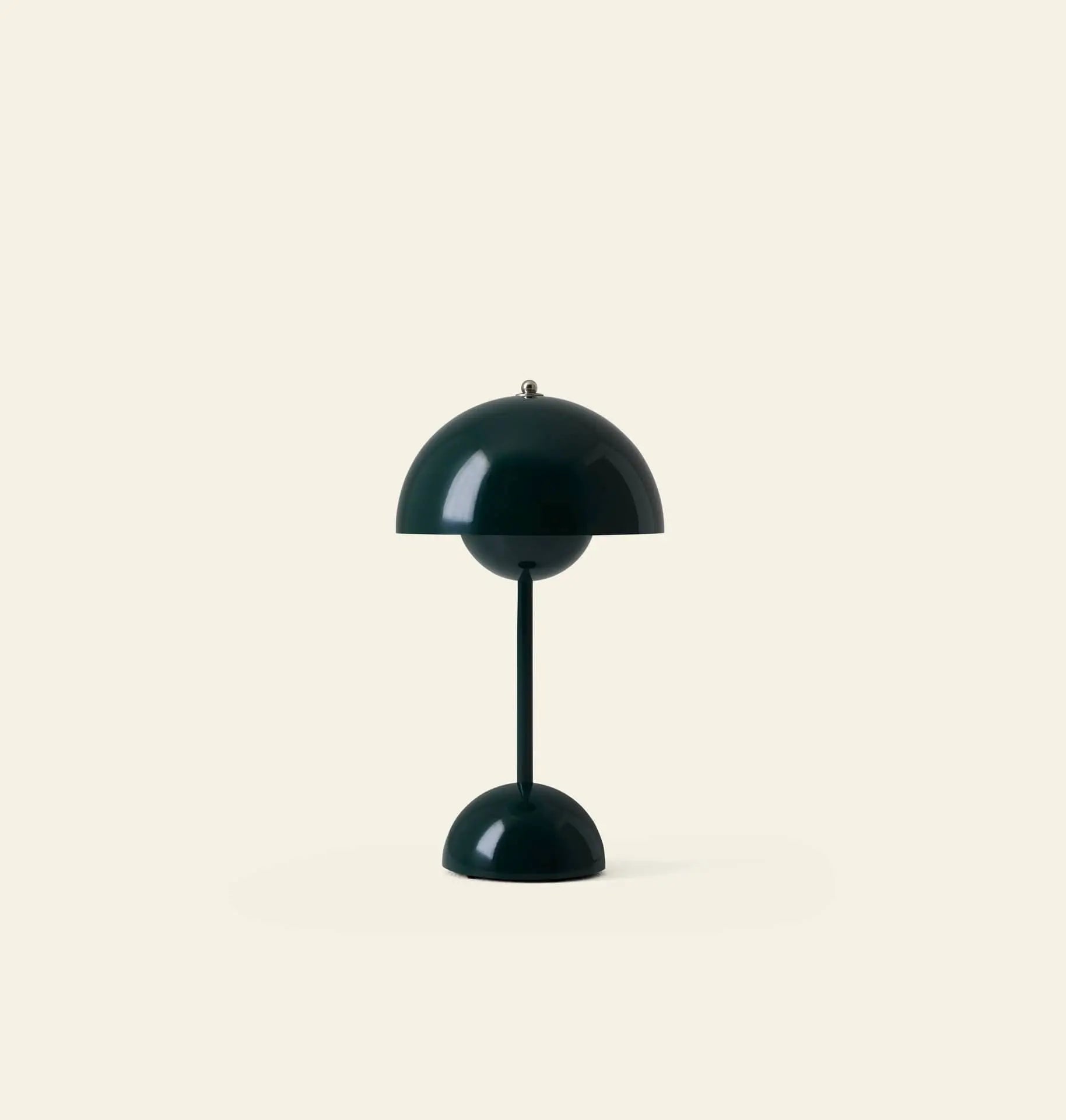 The &Tradition Flowerpot VP9 Portable Table Lamp features a modern, minimalistic design with a dome-shaped dark green shade and base, set against a light beige background. It includes a USB charging cable for convenience.