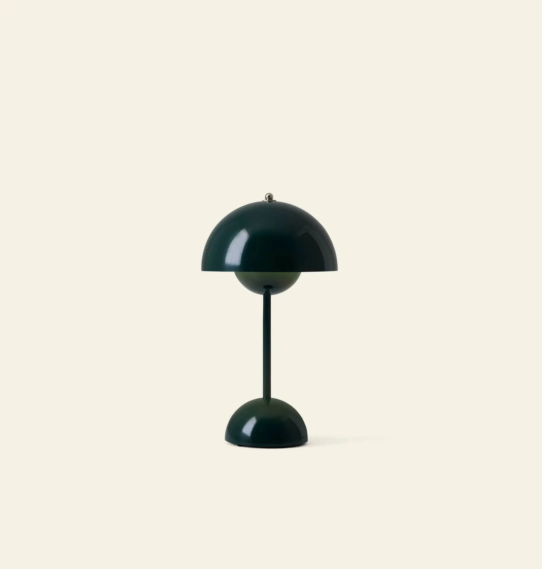 The &Tradition Flowerpot VP9 Portable Table Lamp is a modern dark green lamp with a dome-shaped shade and base on a slim stem, set against a light beige background. This portable lamp includes a USB charging cable for convenience.