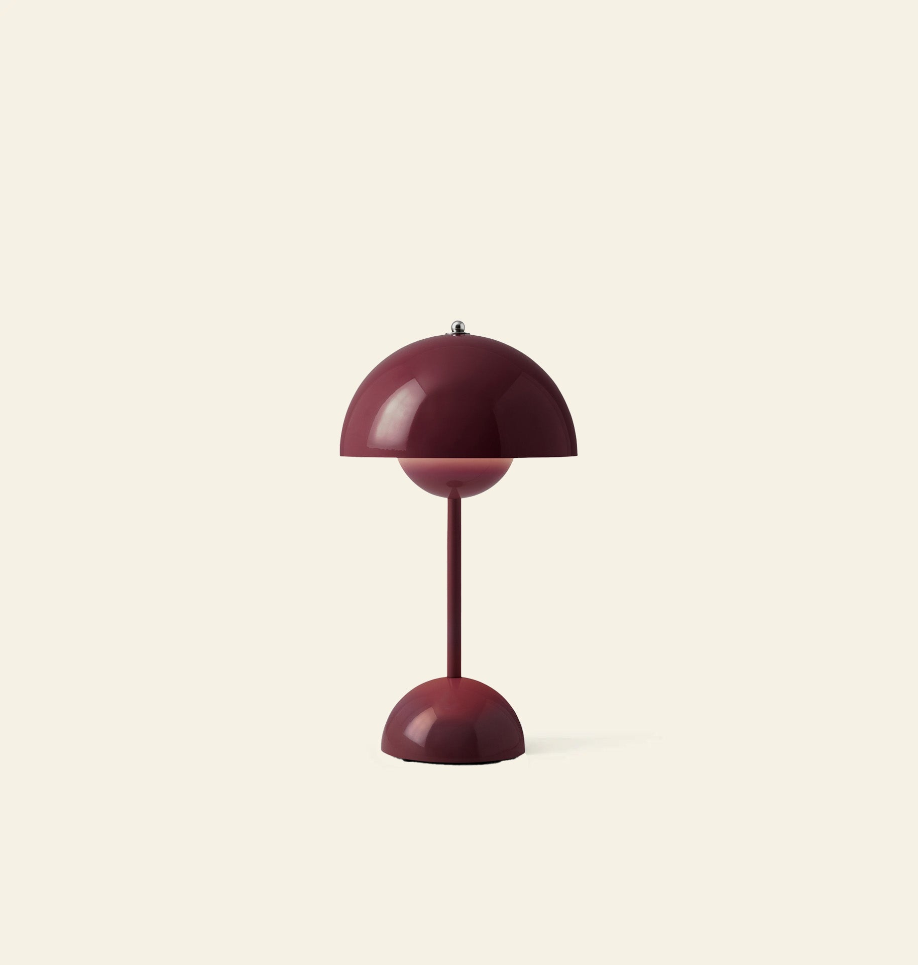 The &Tradition Flowerpot VP9 Portable Table Lamp by &Tradition features a modern burgundy dome-shaped shade and base, set against a light beige background. This stylish lamp comes with a USB charging cable for convenience.