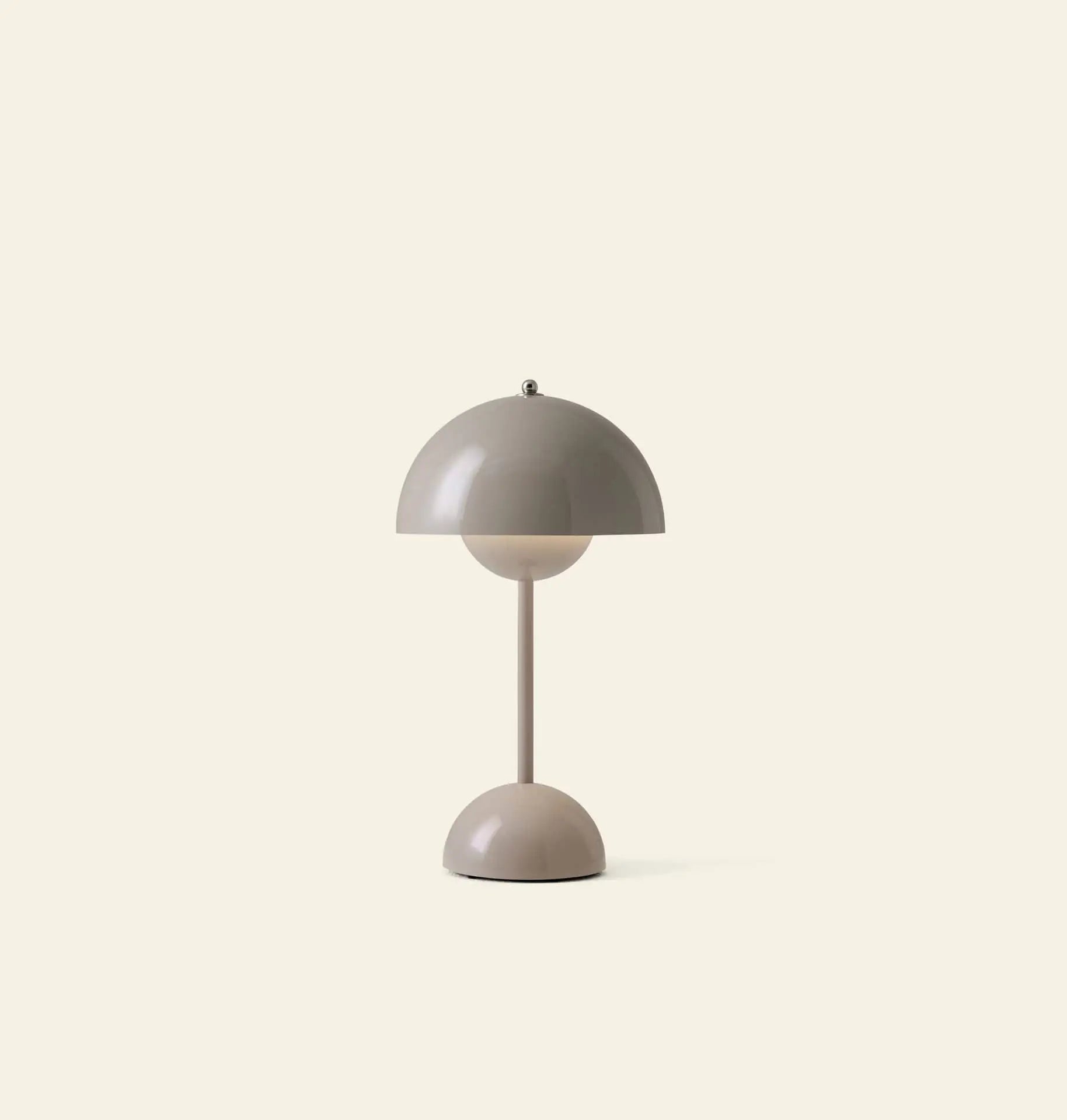 The &Tradition Flowerpot VP9 Portable Table Lamp by &Tradition features a dome-shaped beige shade and base with a slender stem. This modern lamp comes with a USB charging cable and is shown against an off-white background.
