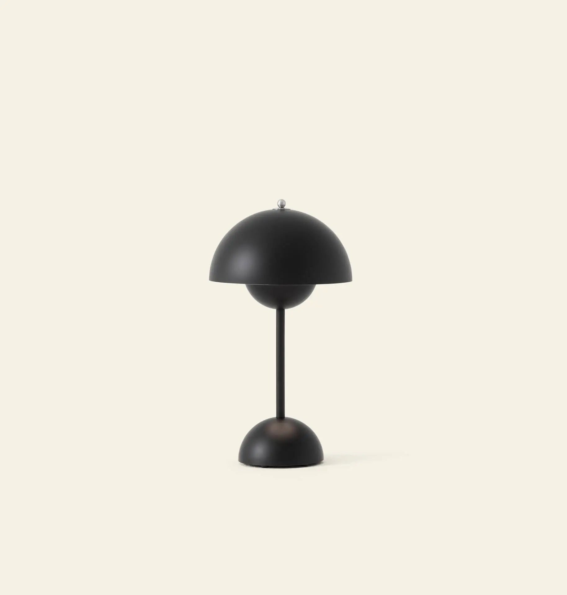 The &Tradition Flowerpot VP9 Portable Table Lamp by &Tradition features a modern black dome-shaped shade and base on a slim stem, includes a USB charging cable, and is set against a plain light beige background.