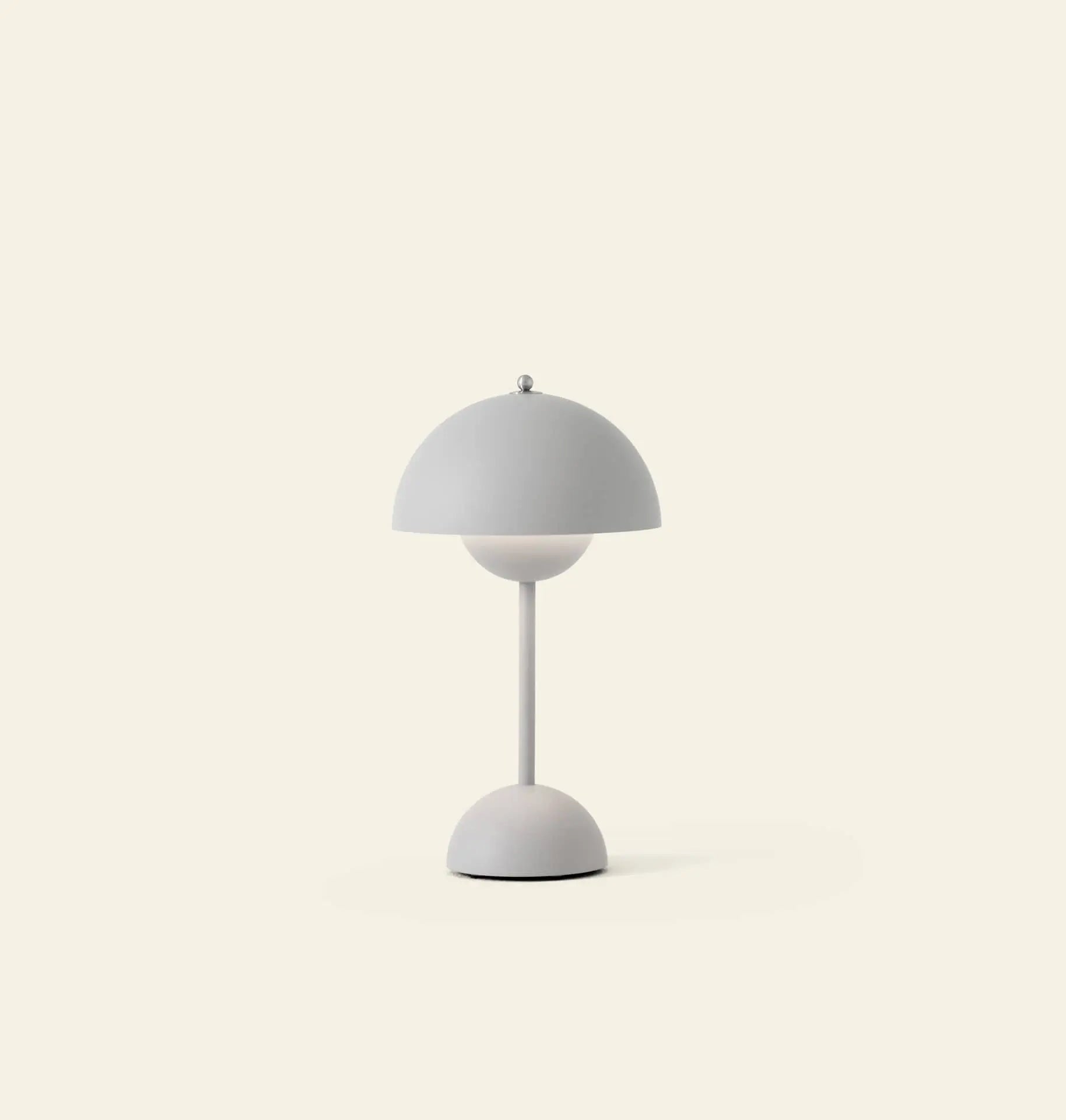 The &Tradition Flowerpot VP9 Portable Table Lamp features a modern dome-shaped shade and sleek stand, shown on a light beige background. This minimalist piece includes a USB charging cable for convenient use anywhere.
