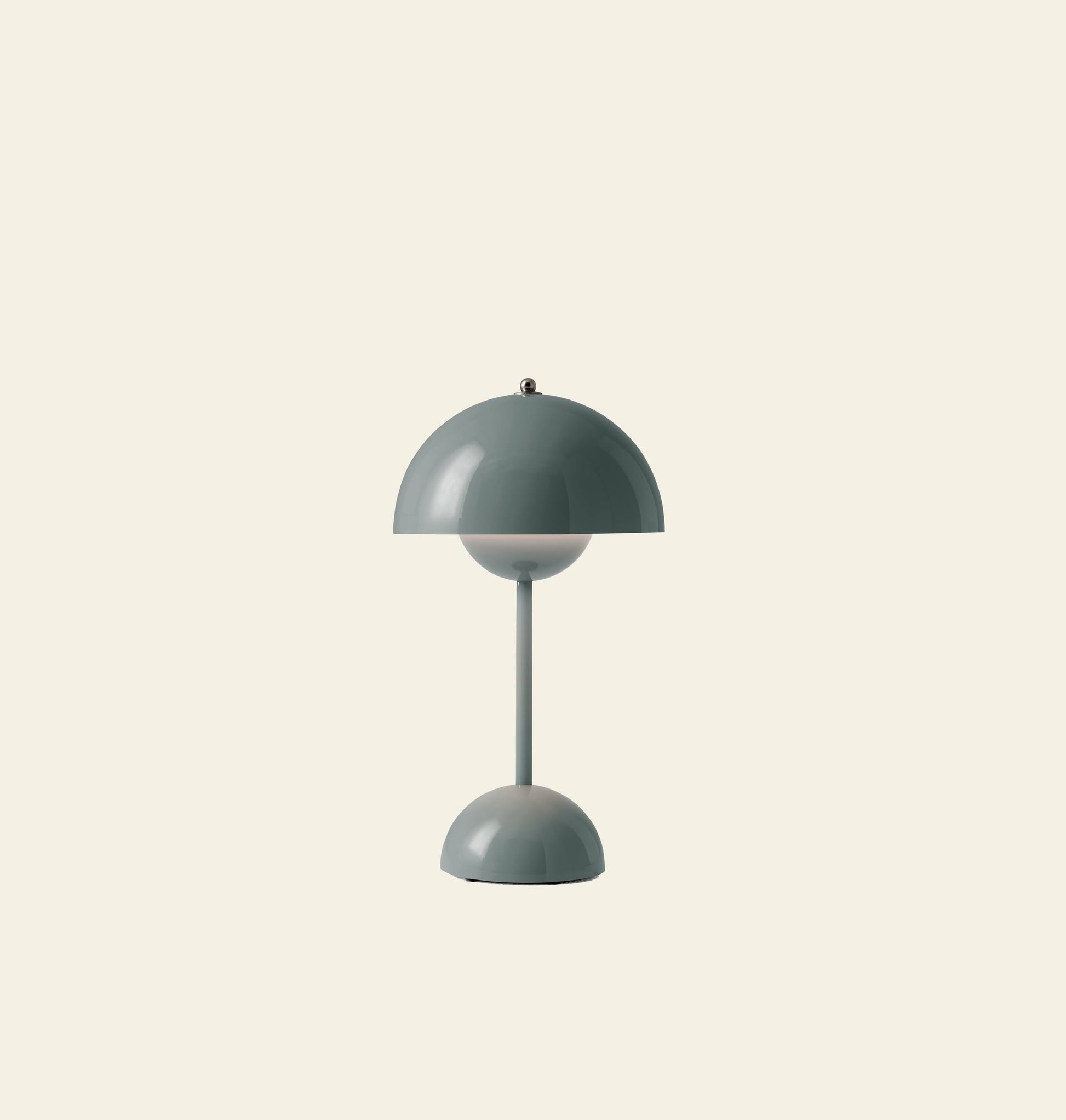 The &Tradition Flowerpot VP9 Portable Table Lamp features a minimalist dome-shaped shade and base in muted green on a beige backdrop. This portable lamp comes with a USB charging cable for easy recharging anywhere.