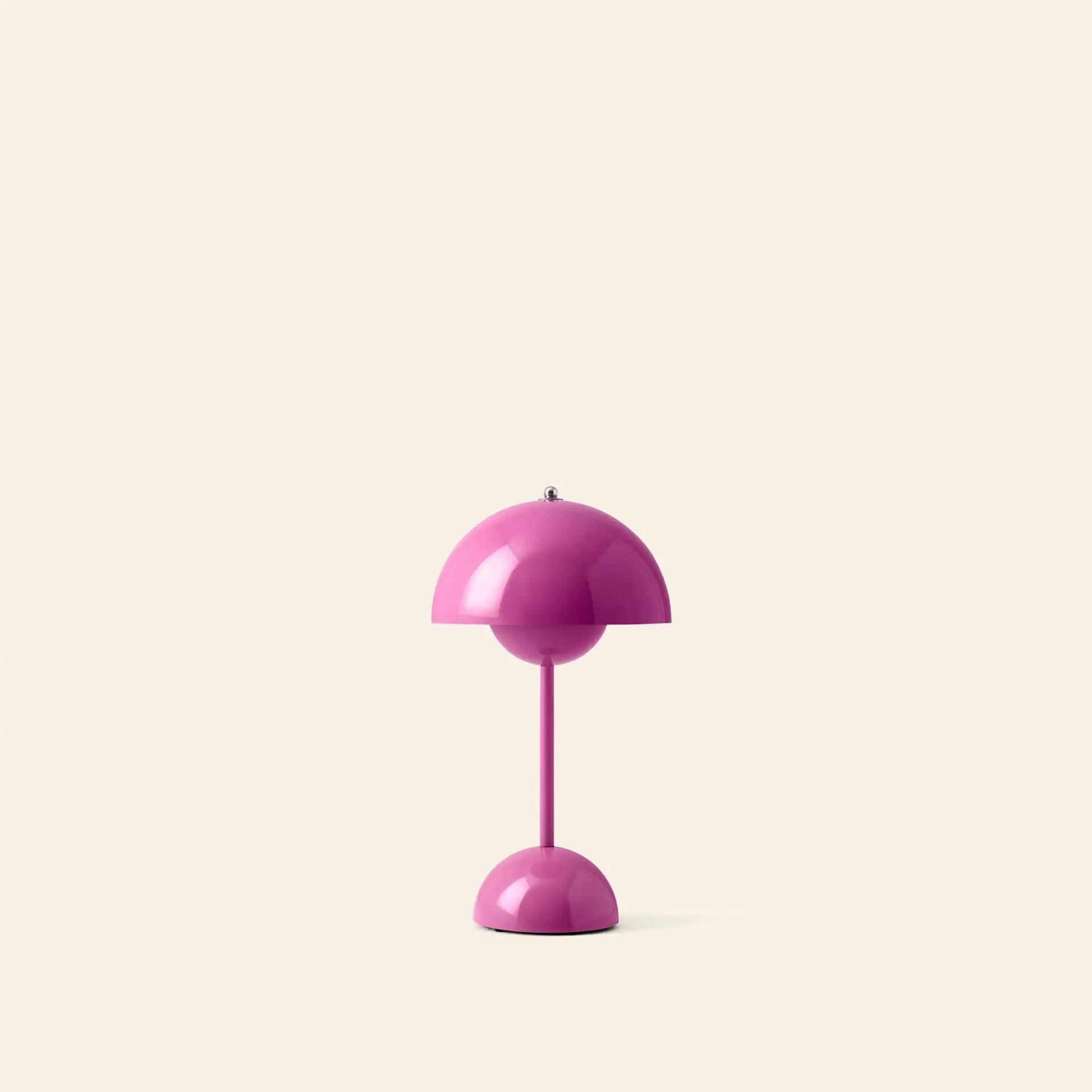 The &Tradition Flowerpot VP9 Portable Table Lamp features a modern pink dome-shaped shade and base, set against a cream background, and includes USB charging for easy portability.