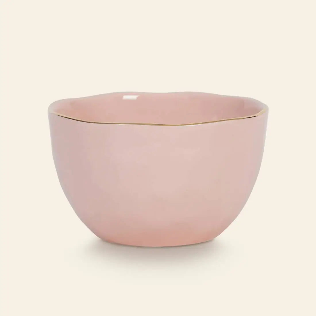 The Urban Nature Culture Good Morning Bowl features a soft pink pastel hue, a gently wavy rim, and a delicate gold edge—ideal for breakfast, styled simply against an off-white background.