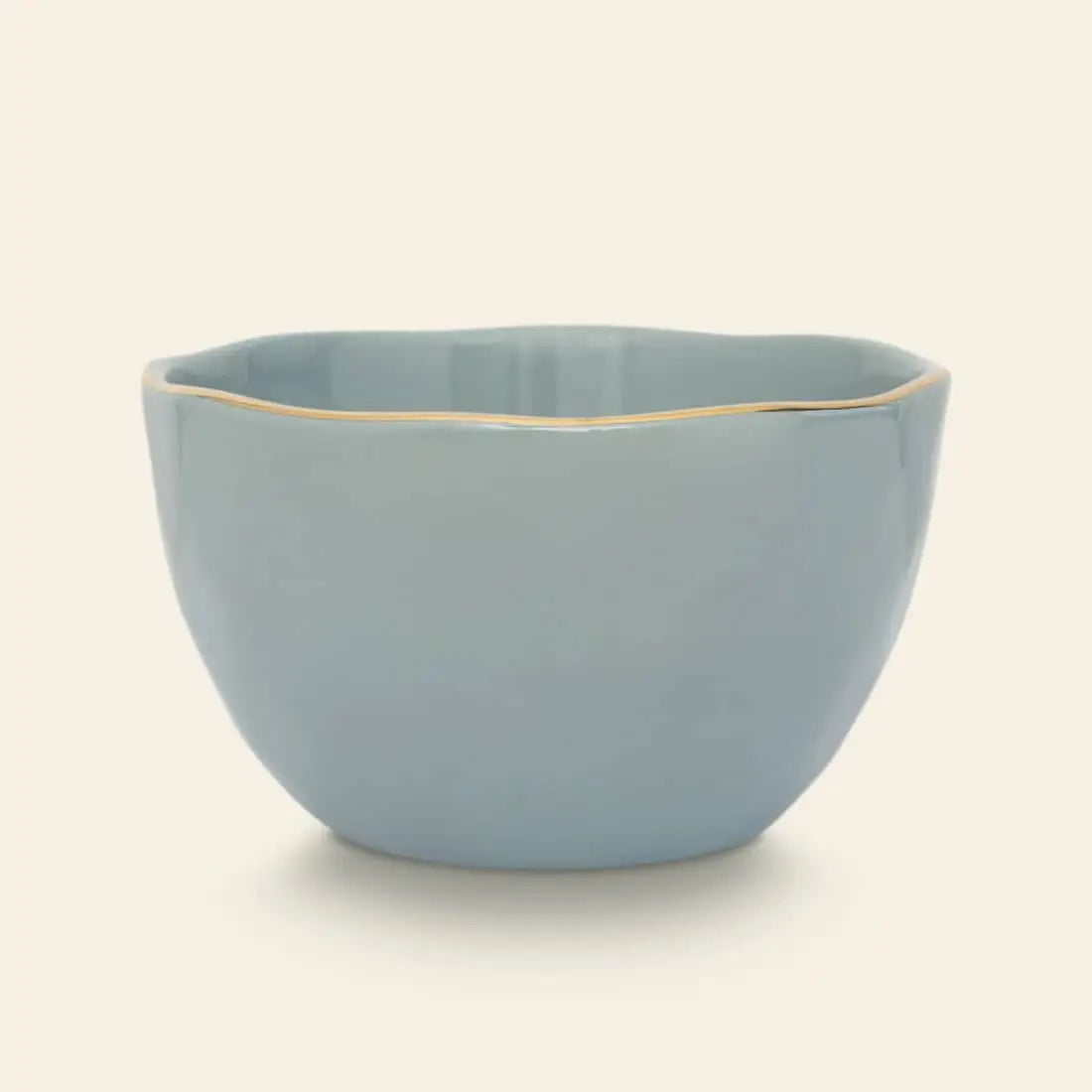 The Urban Nature Culture Good Morning Bowl is a light blue ceramic piece with wavy edges and a gold rim, set against a plain background—ideal for serving breakfast.