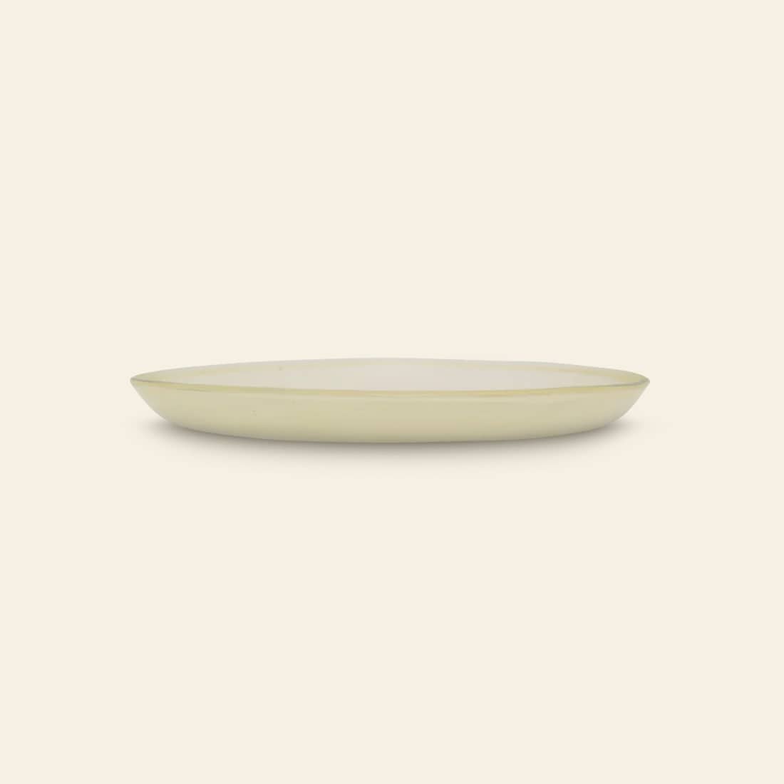 A round, off-white Urban Nature Culture Plate Recycled Glass Frost with a slightly raised rim, shown side view on a plain background—highlighting Urban Nature Culture’s dedication to eco-friendly design.