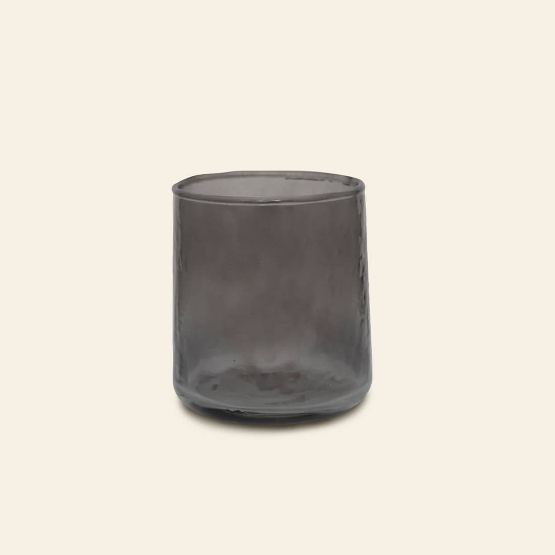 The Urban Nature Culture Tumbler Recycled Glass features translucent smoky gray recycled glass with a slightly uneven texture and eco-friendly design, set against a plain light beige background.