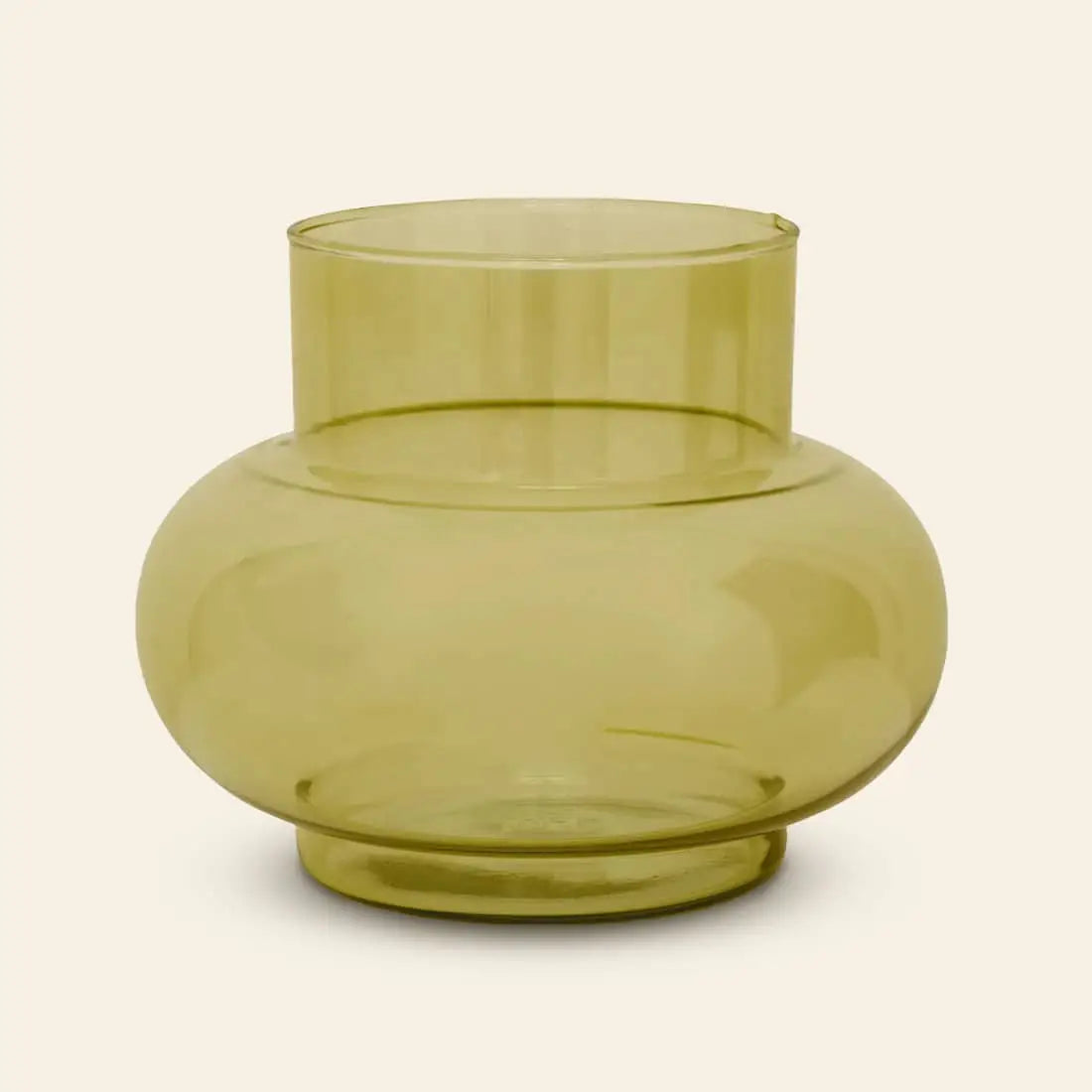 The Urban Nature Culture Vase Recycled Glass Tummy B features a translucent yellow, wide-bodied design with a narrow cylindrical neck, bringing a fresh touch to any décor and sitting elegantly against a light background.
