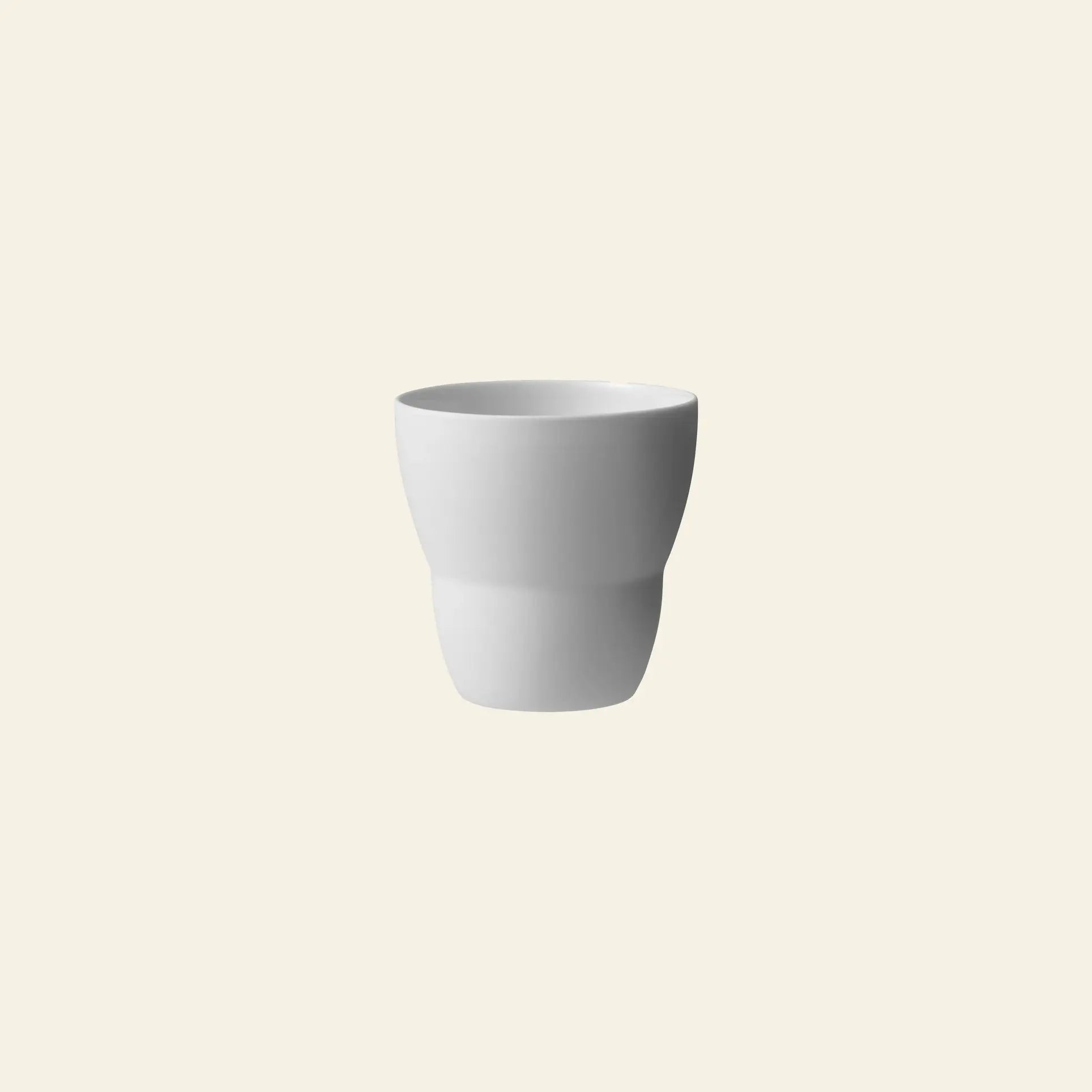 The Vipp Vipp201 Espresso Cups, Set of 2 by Vipp feature a minimalist, modern design in white porcelain and are shown centered on a light beige background.