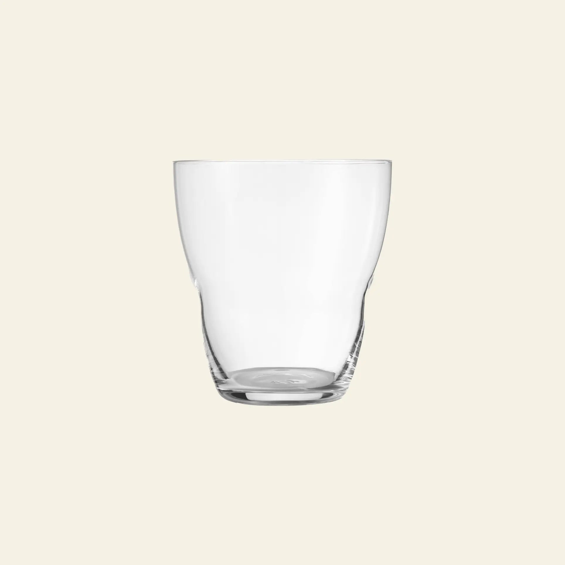 The Vipp Vipp240 Glasses 5oz, Set of 2 by Vipp are shown empty against a light beige background, highlighting their luxury design with a simple curved shape and thick base—a testament to mouth-blown craftsmanship.