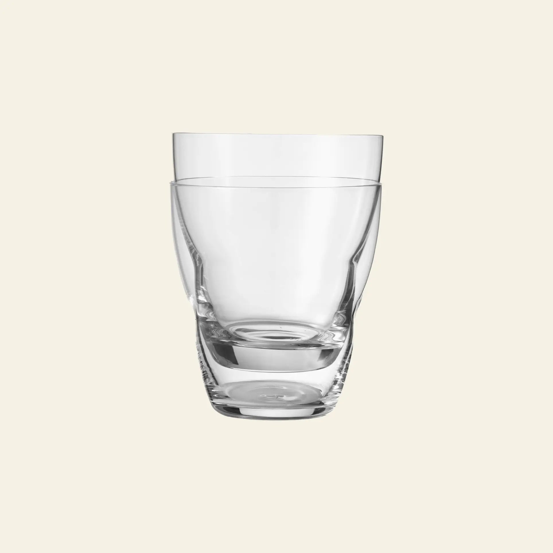 A pair of clear, empty Vipp Vipp240 Glasses 5oz by Vipp—featuring mouth-blown craftsmanship—are stacked together against a plain light beige background.