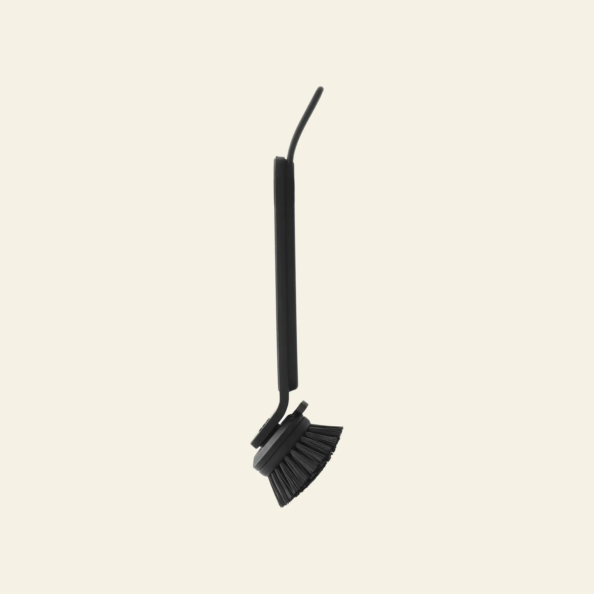 The Vipp Vipp280 Dishwashing Brush by Vipp features a long handle and angled bristles, shown standing upright against a light beige background—ideal for efficient kitchen cleaning.