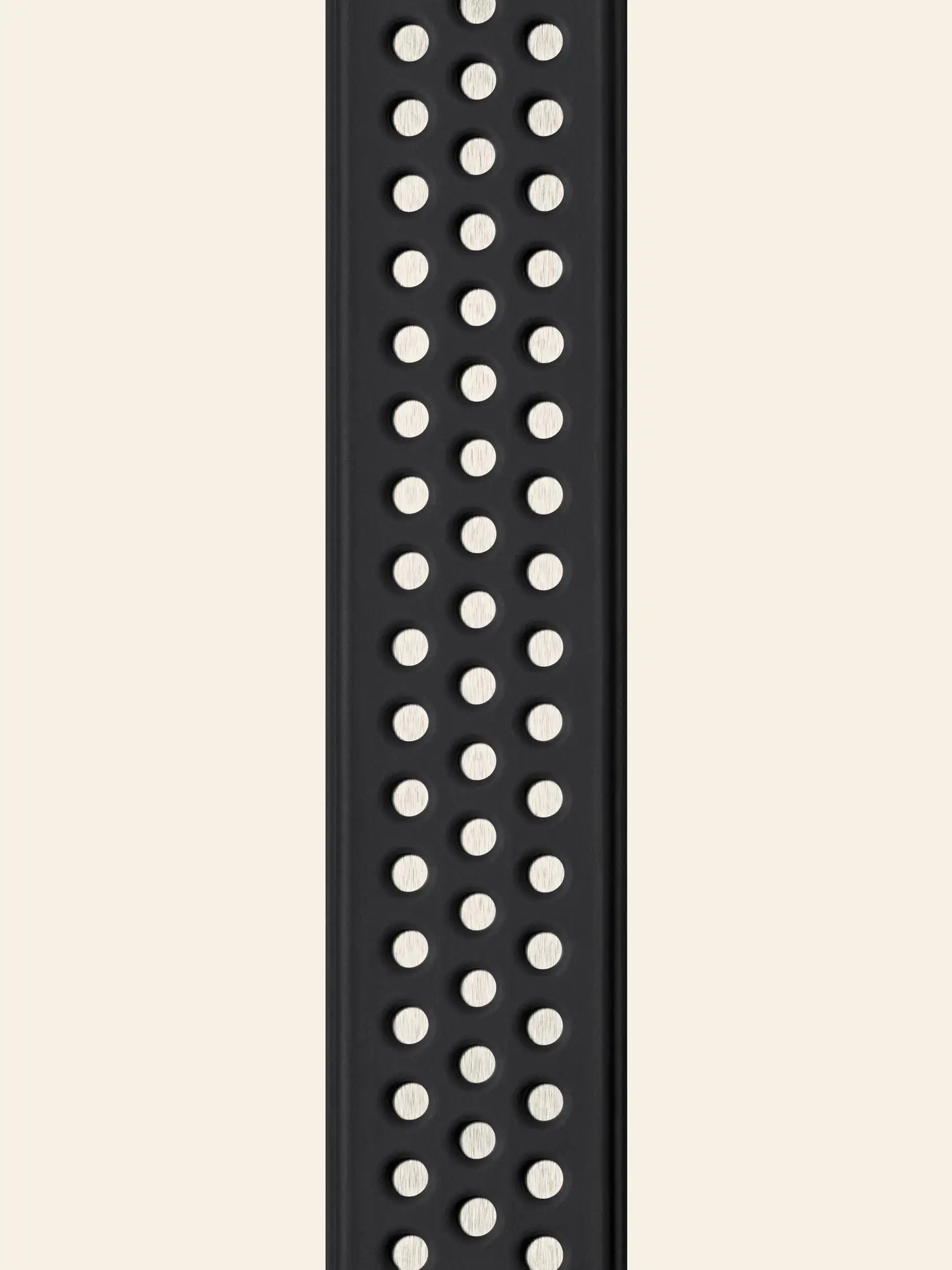 A close-up of a black silicone watch band with evenly spaced circular holes, echoing the functional design of the replaceable brush head found on the Vipp Vipp280 Dishwashing Brush by Vipp.