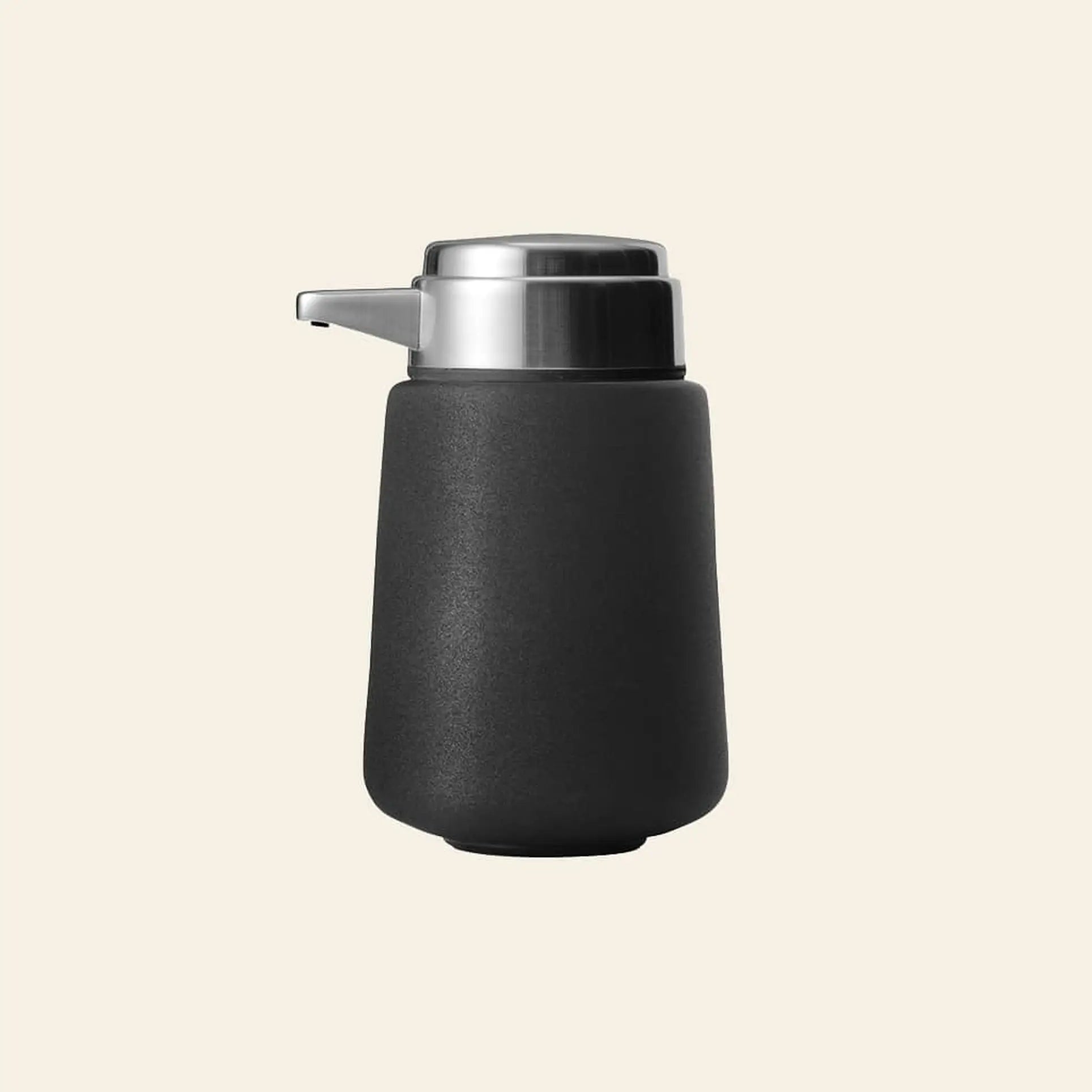 The Vipp Vipp9 Dispenser by Vipp features a matte black finish and metallic pump, creating a sleek kitchen accessory displayed against a plain beige background.