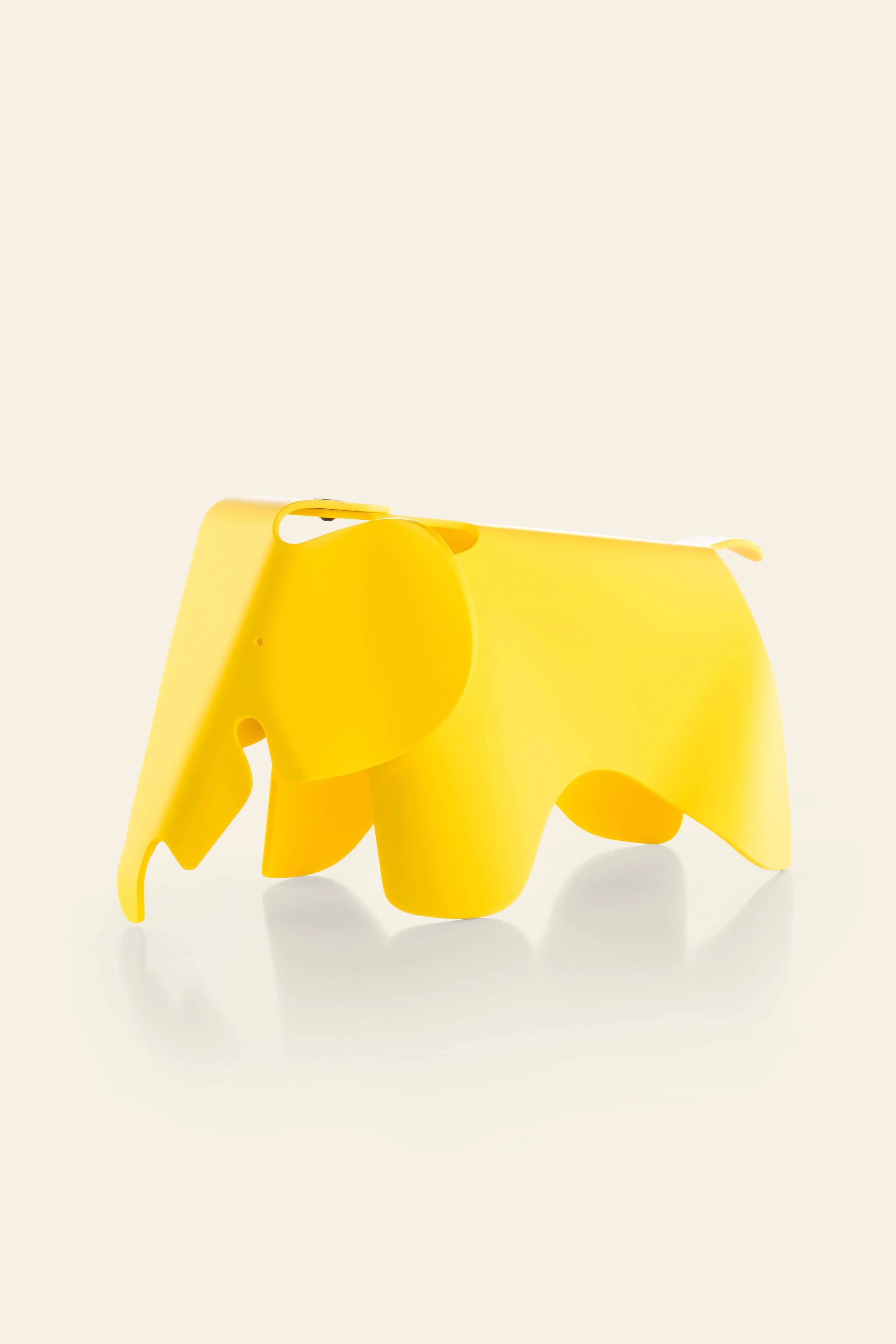 The Vitra Eames Elephant, Small by Vitra is a bright yellow, smooth plastic decorative piece with a minimalist design and abstract detailsโan iconic, playful accent for any modern space.