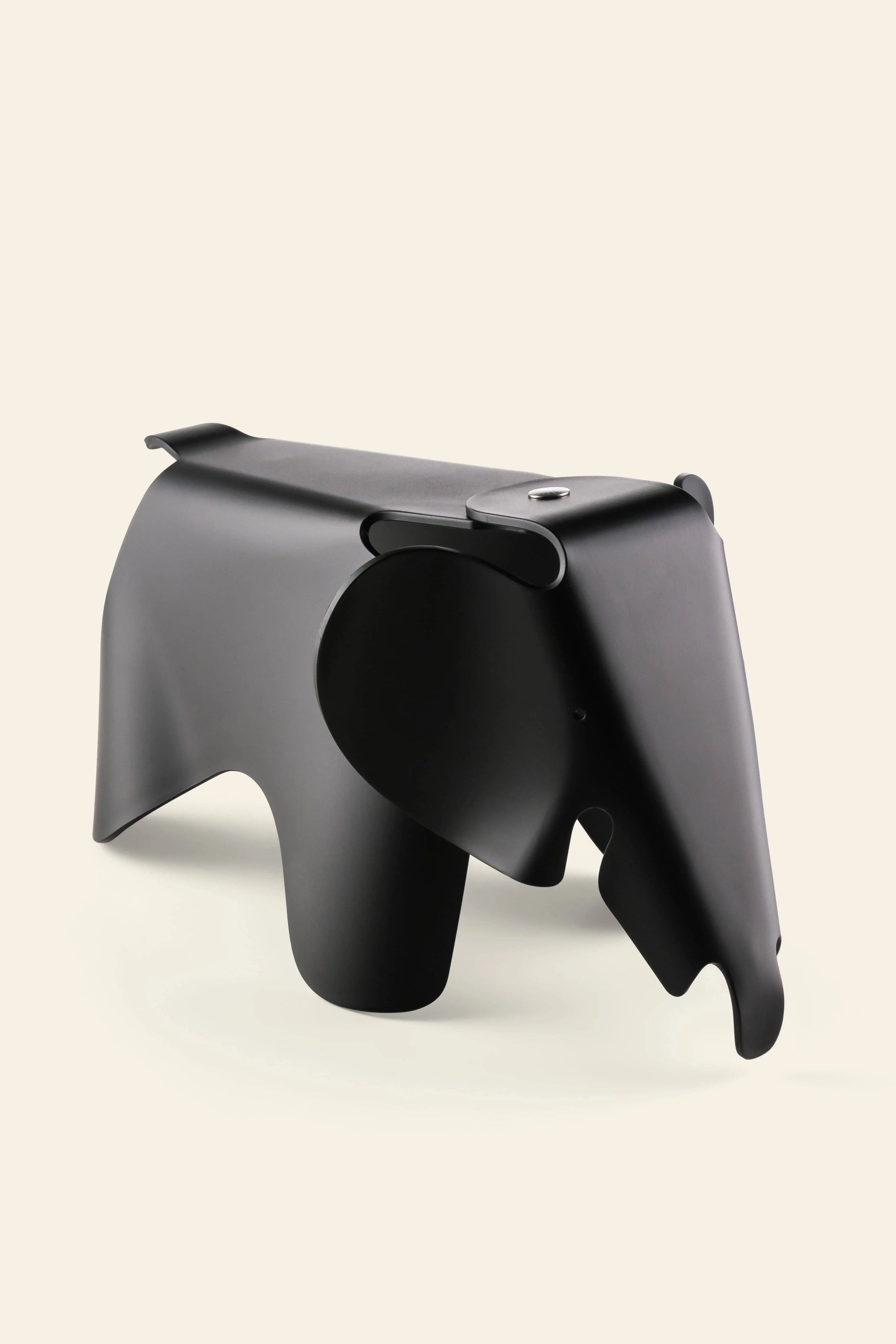 The Vitra Eames Elephant, Small by Vitra is a minimalist black sculpture with smooth curves and abstract features, making it an iconic decorative accent against a plain light background.