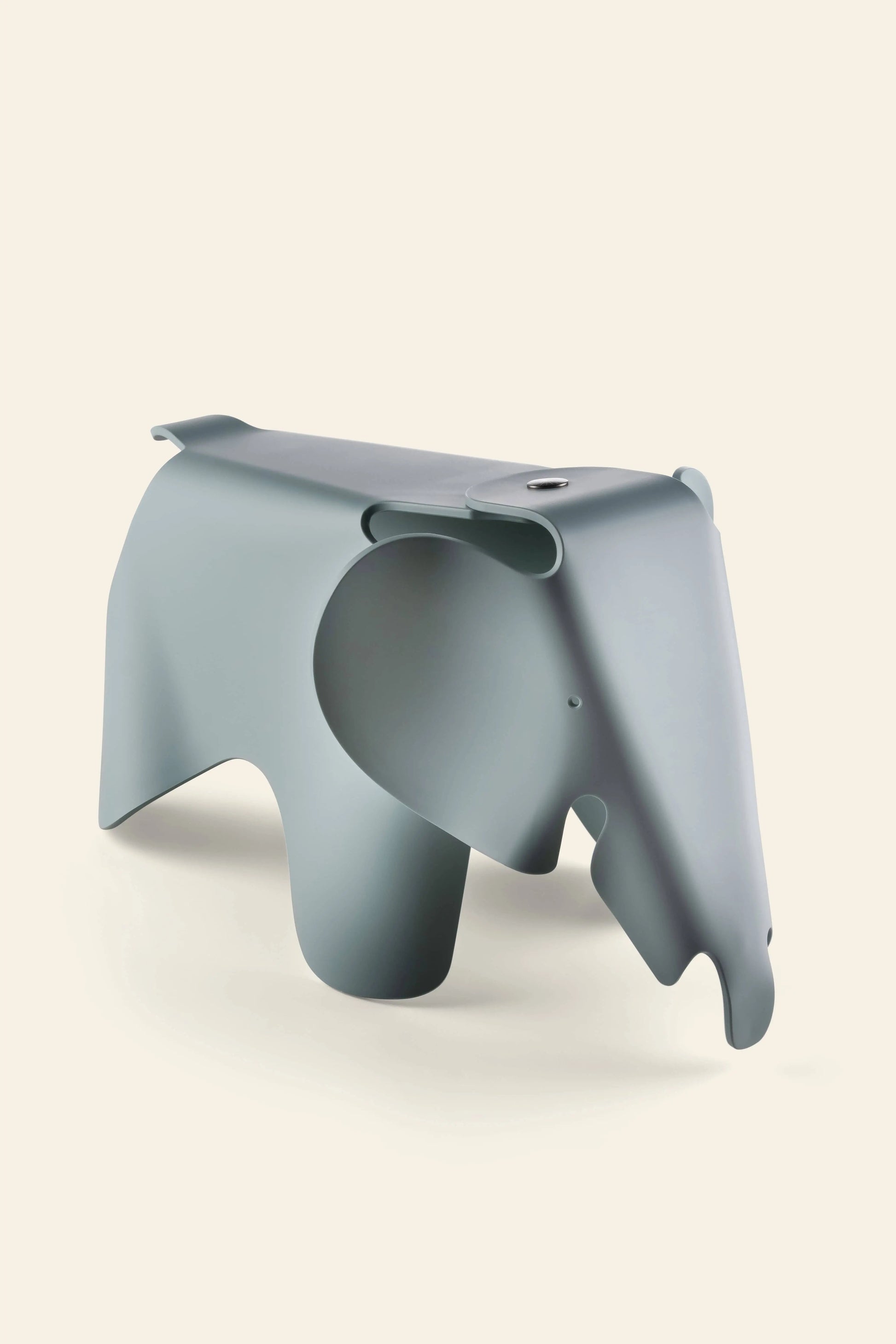 The Vitra Eames Elephant, Small by Vitra is a minimalist gray plastic sculpture with stylized features, adding an iconic decorative touch against a plain light beige background.
