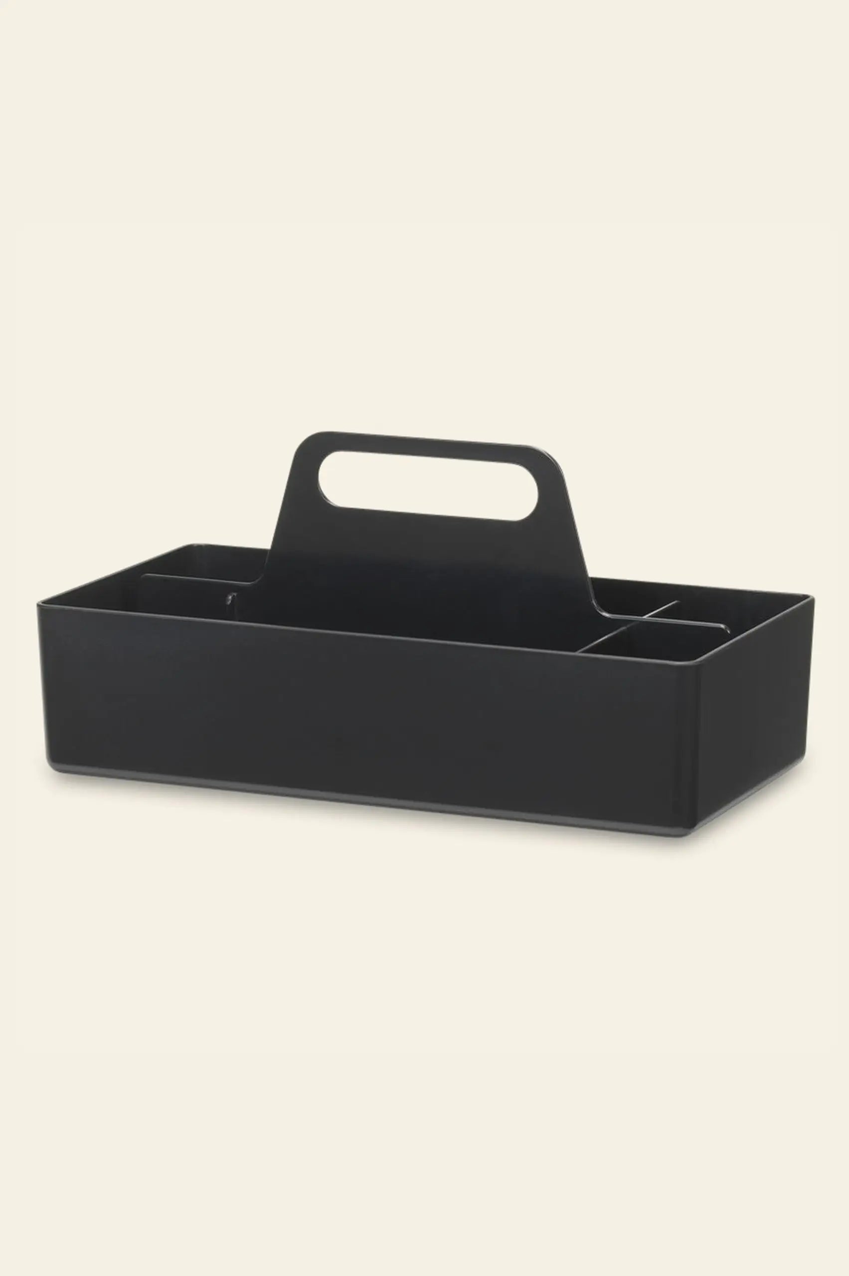 The Vitra Toolbox RE by Vitra is a black rectangular caddy with a central handle and multiple compartments, crafted from recycled ABS plastic and shown on a plain light background.