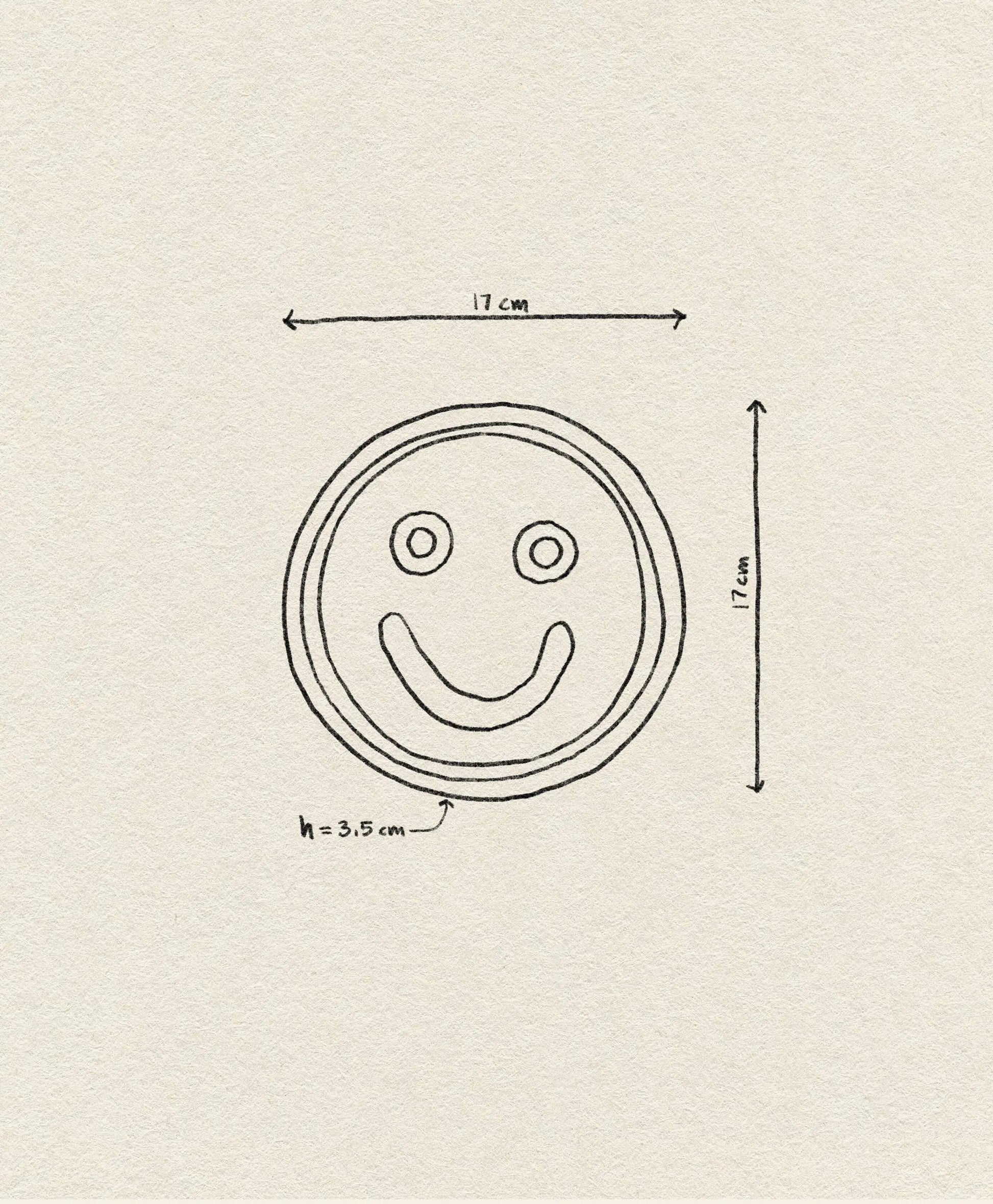 The Wobbly Studio Mood Tray by Wobbly Studio features a hand-drawn smiley face (17 cm diameter, 3.5 cm height) on off-white textured paper—perfect for a personalized display.