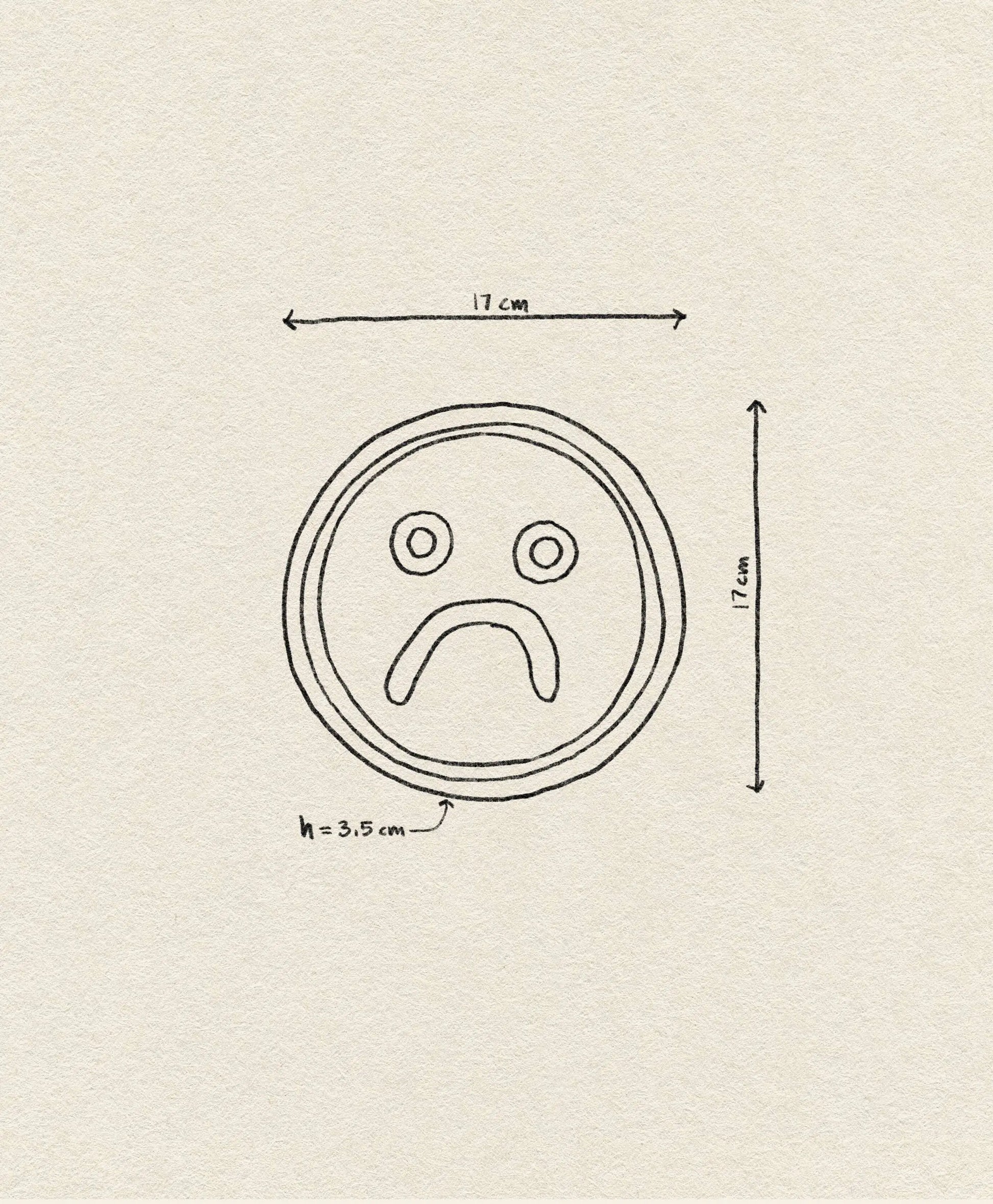 The Wobbly Studio Mood Tray features a hand-drawn sad face in a 17 x 17 cm circle with a 3.5 cm mouth, displayed on textured beige paper—perfect for personalizing your space.