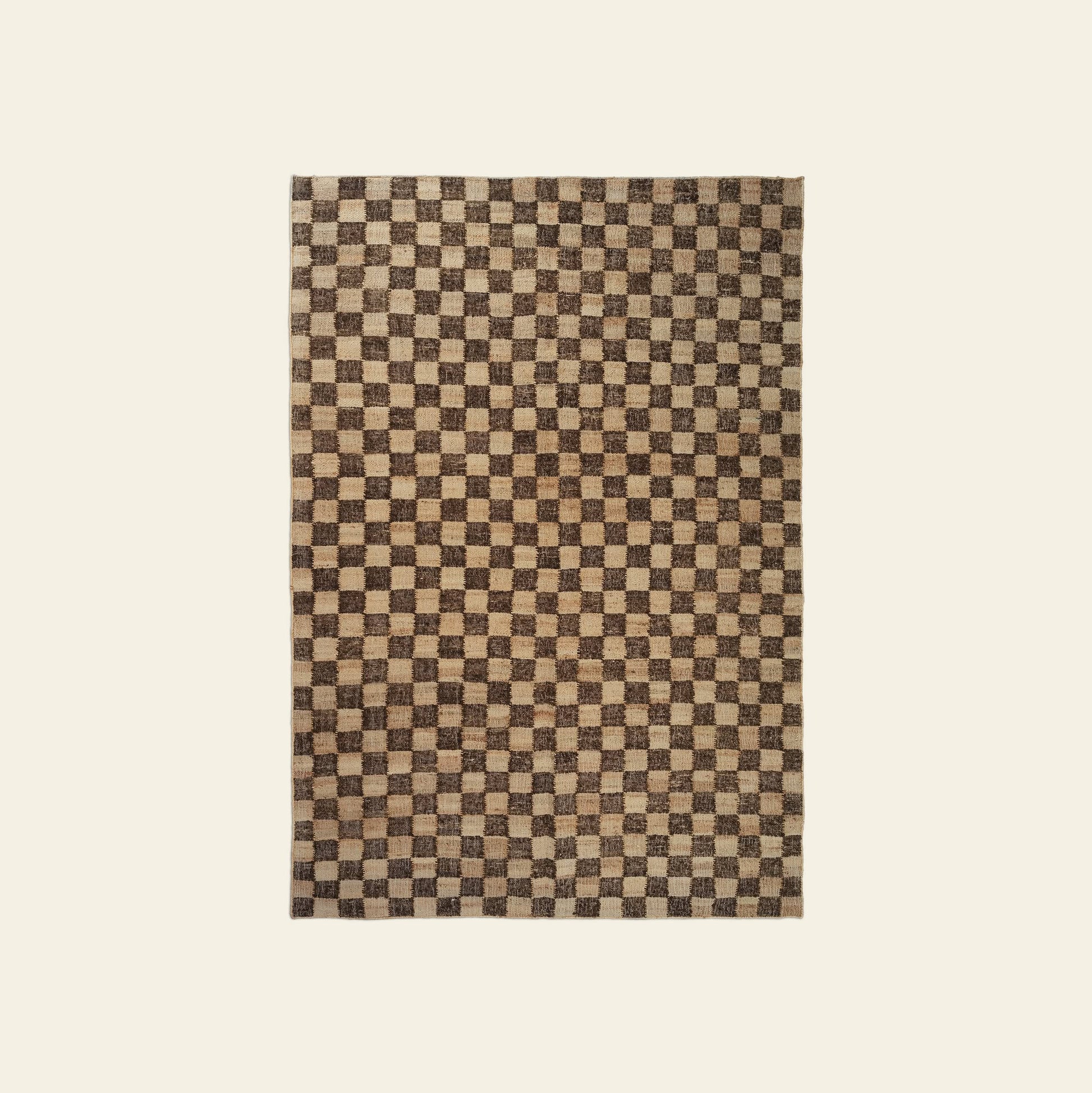 The ferm LIVING Check Wool Jute Rug (200x300) features a timeless rectangular check pattern in brown and beige tones, displayed on a plain off-white background.