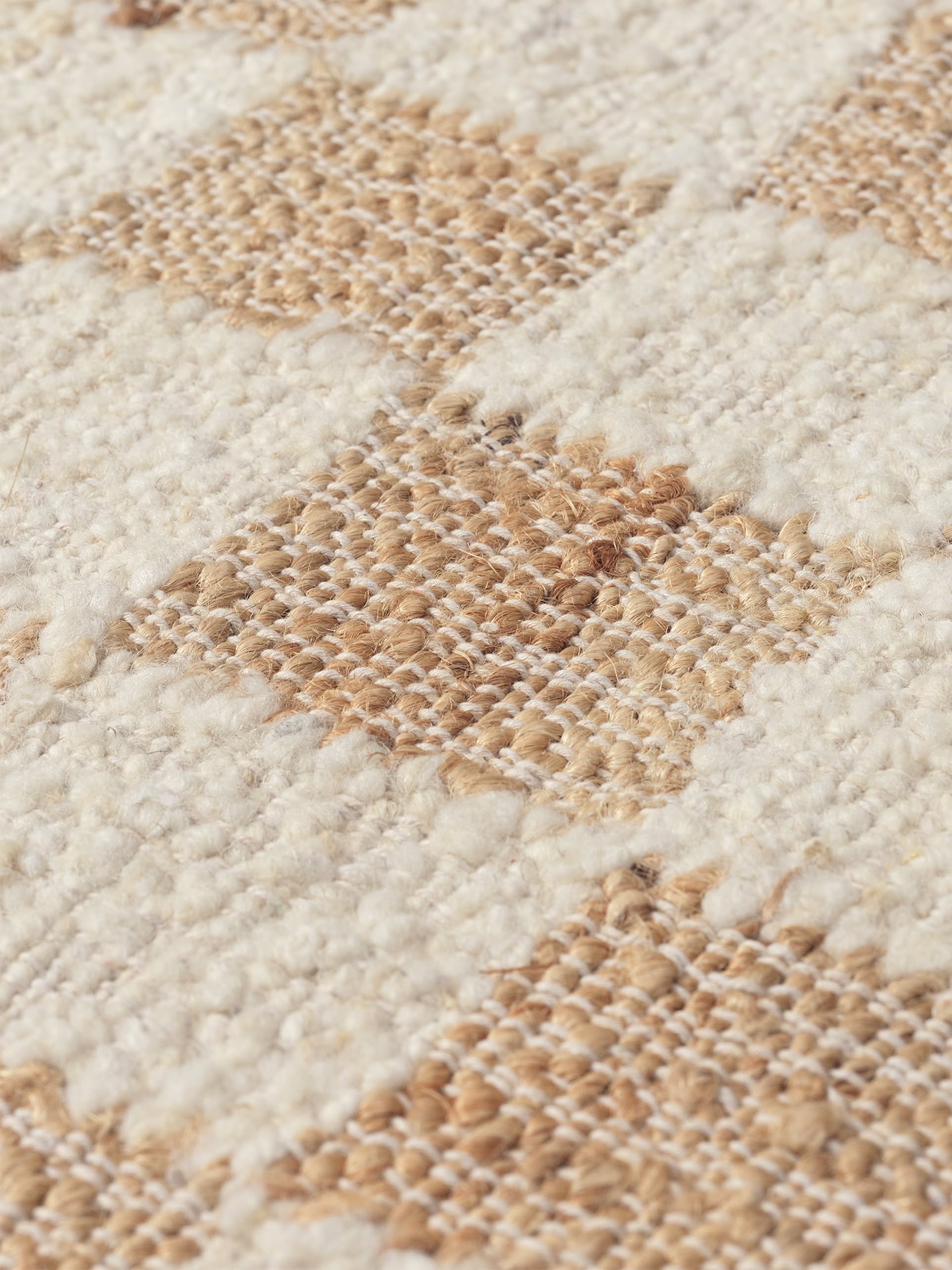 Close-up of the ferm LIVING Check Wool Jute Rug (200x300), showcasing its intricate cream and light brown check pattern and textured weave, highlighting the signature craftsmanship of ferm LIVING.