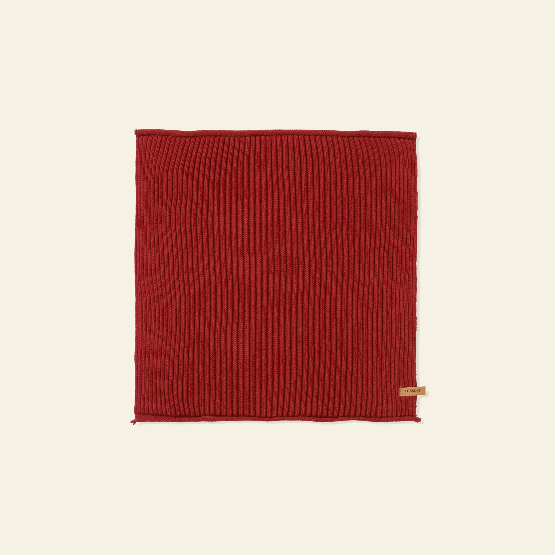A set of seven rectangular, ribbed, red organic cotton Day Cloths by ferm LIVING, each featuring a small beige tag on one edge, is laid flat on a plain light background.
