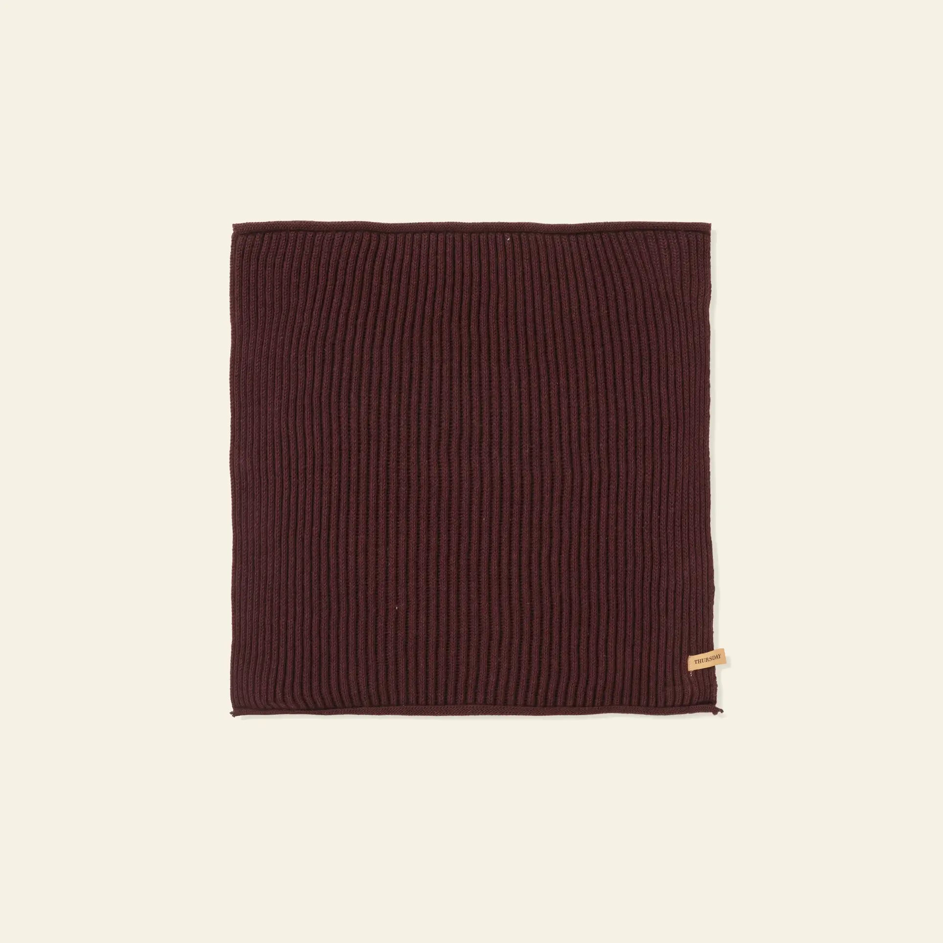 A set of 7 rectangular, ribbed, dark brown knit cloths by ferm LIVING, made from GOTS-certified organic cotton with a small beige tag on the bottom right, displayed on a plain light background.