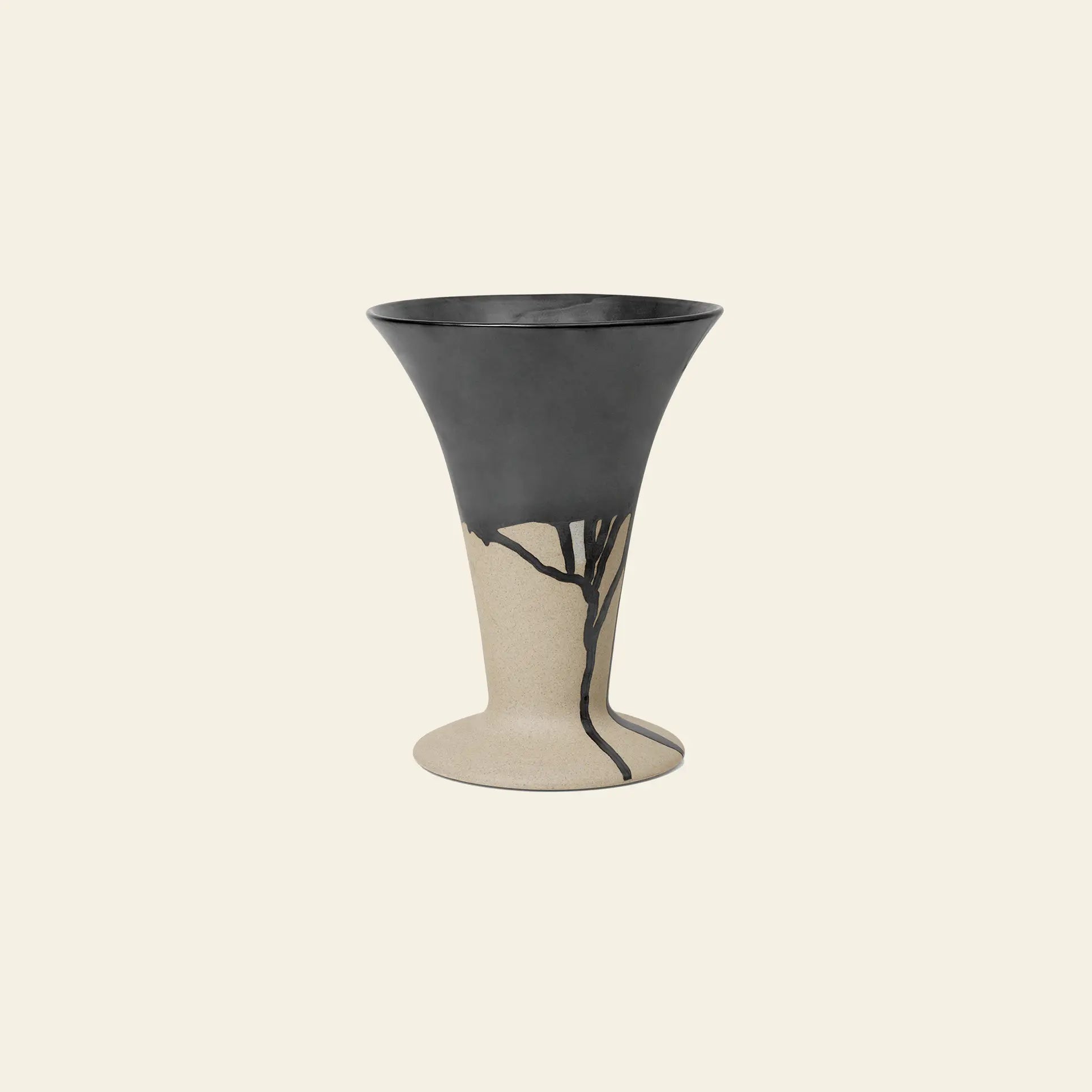 The ferm LIVING Flores Vase by ferm LIVING features a wide, flared rim and a matte black top half that fades into beige with black, branch-like lines, creating a modern tulipiere look against a light background.
