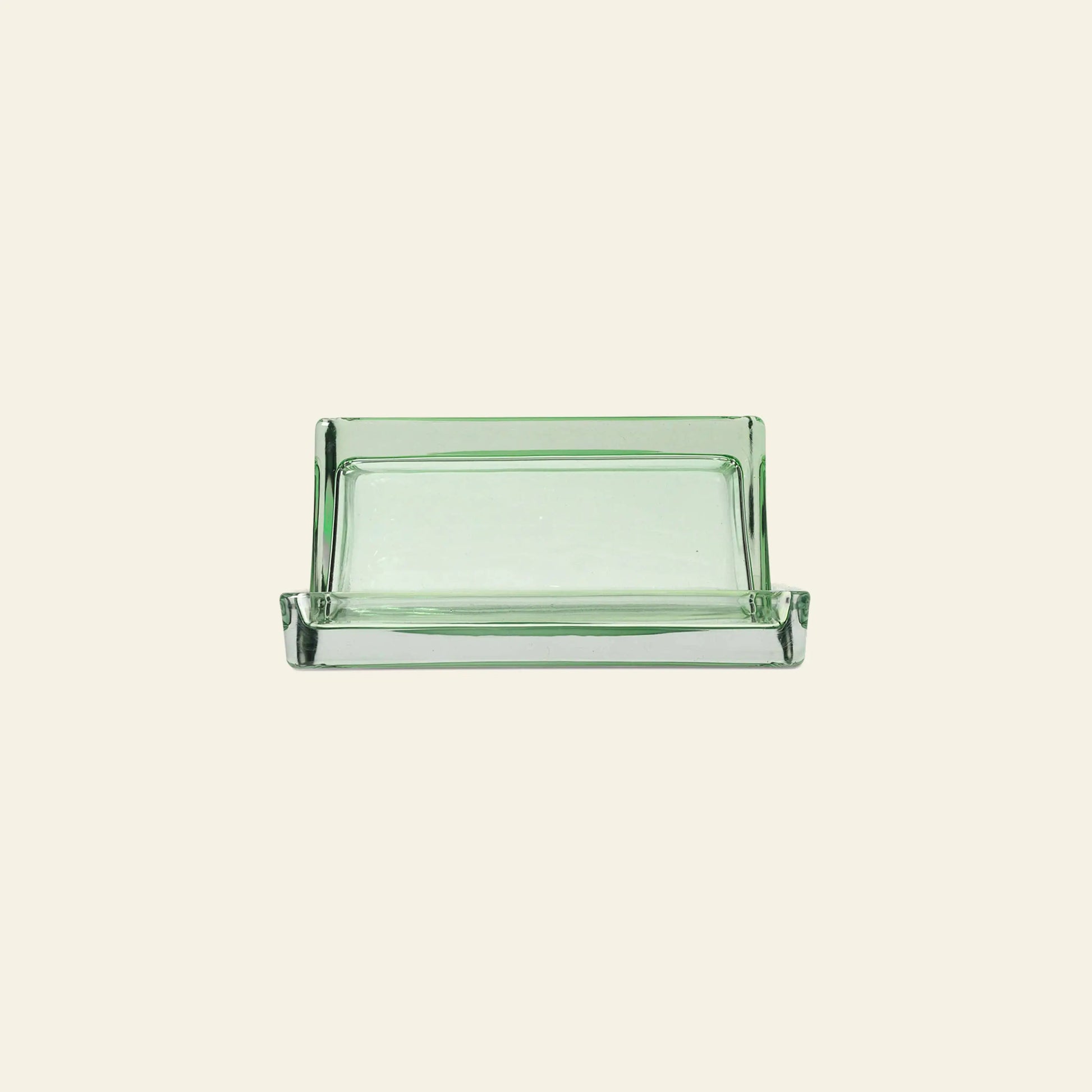 The ferm LIVING Oli Box by ferm LIVING is a rectangular, clear recycled glass soap dish with slightly raised edges, shown against a plain light beige background.